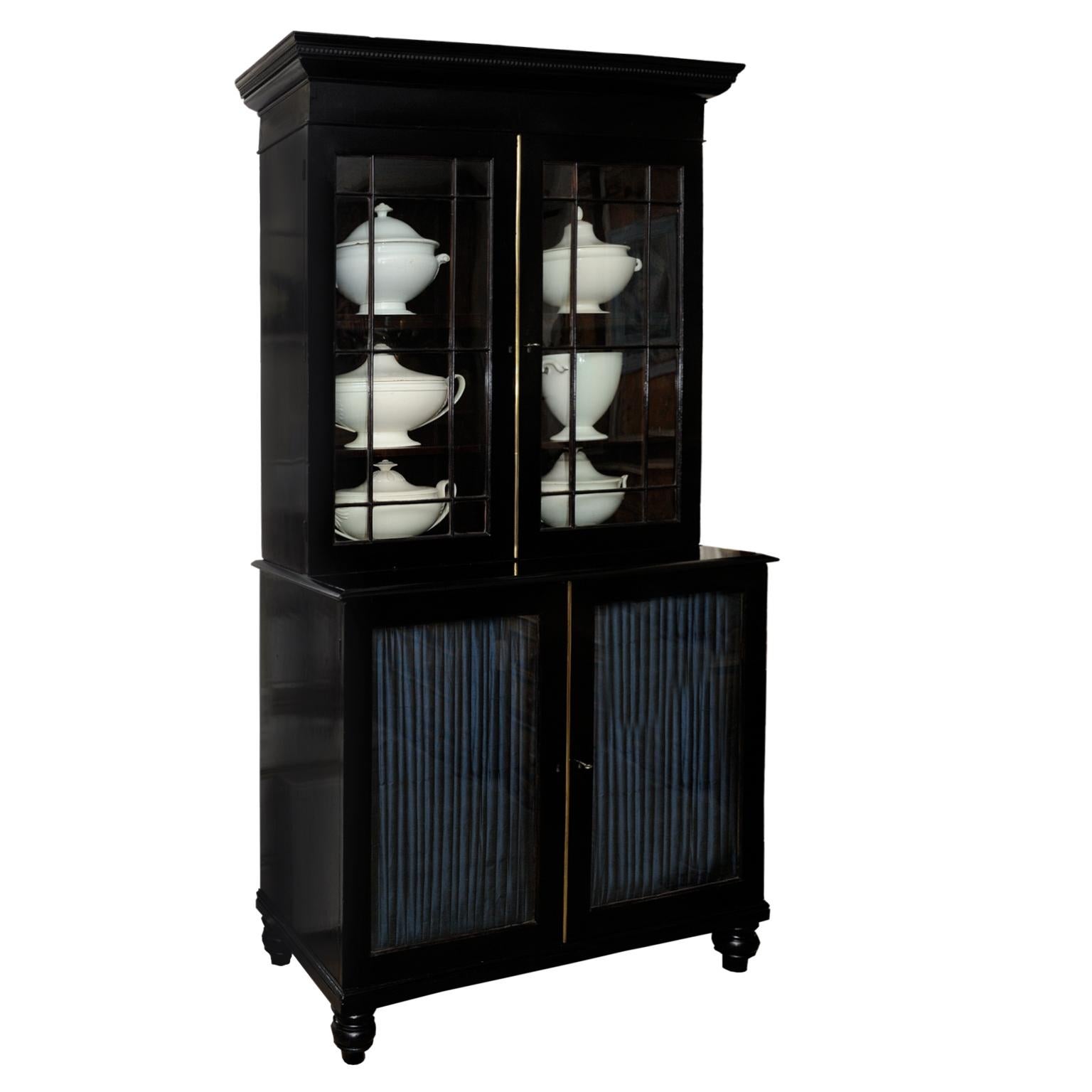This is a lovely? large English George III ebonised library Bookcase with astragal glazed top and fully adjustable shelves with pleated silk to the lower section, circa 1780. 

A super piece of great proportions