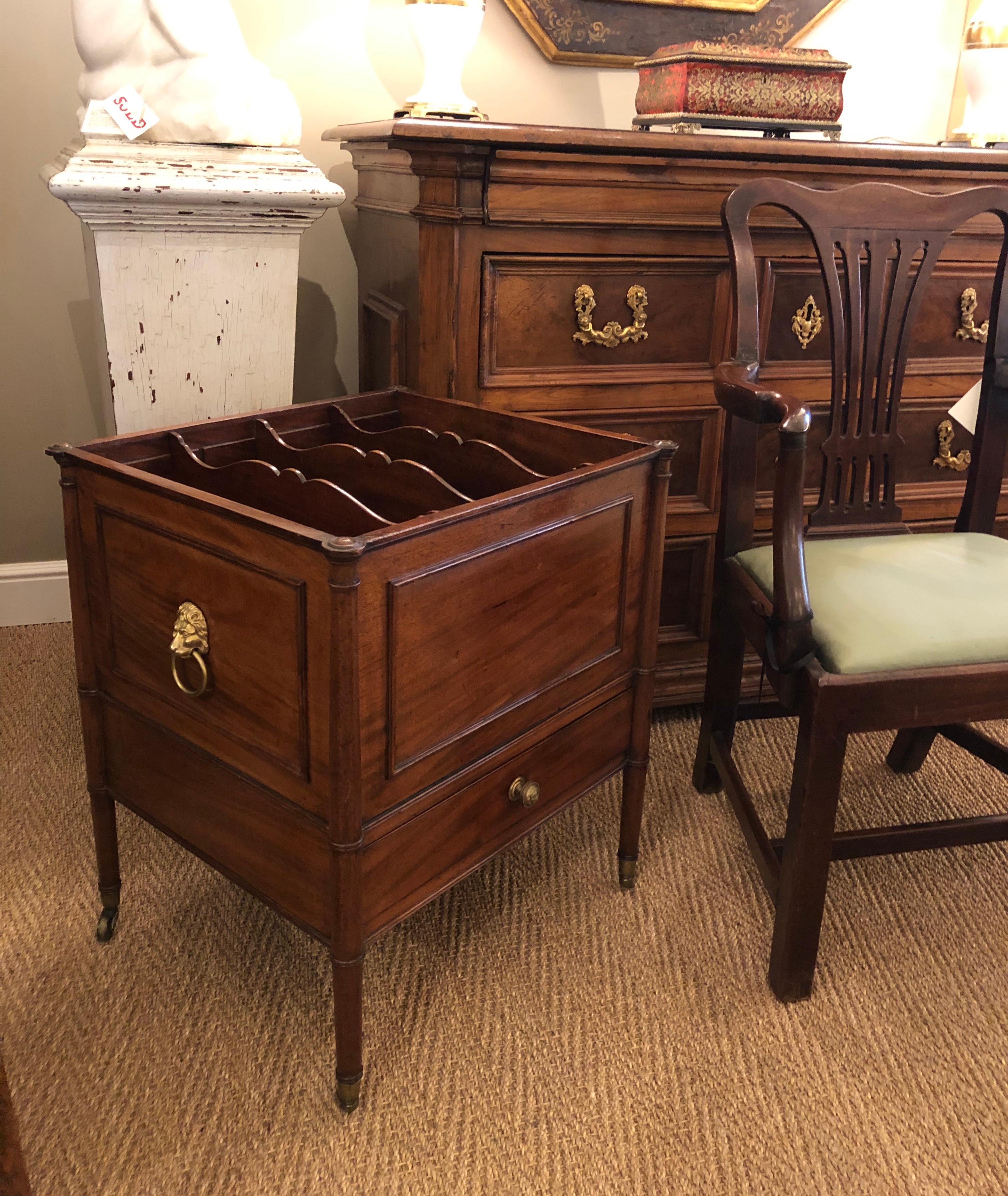 One of the largest and best qualities Georgian Canterbury's, fitted with 3 adjustable serpentine dividers within a rectangular body with applied moldings and lion ring handles, the columnar corners continuing to tapering legs on brass casters.