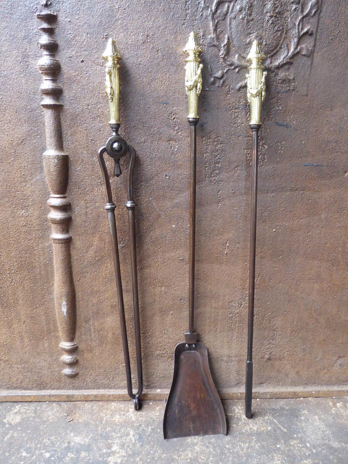 Beautiful set of three English Georgian fireplace tools made of wrought iron with polished brass handles. Late 18th or early 19th century. The fire tool set is in a good condition and is fully functional.








 