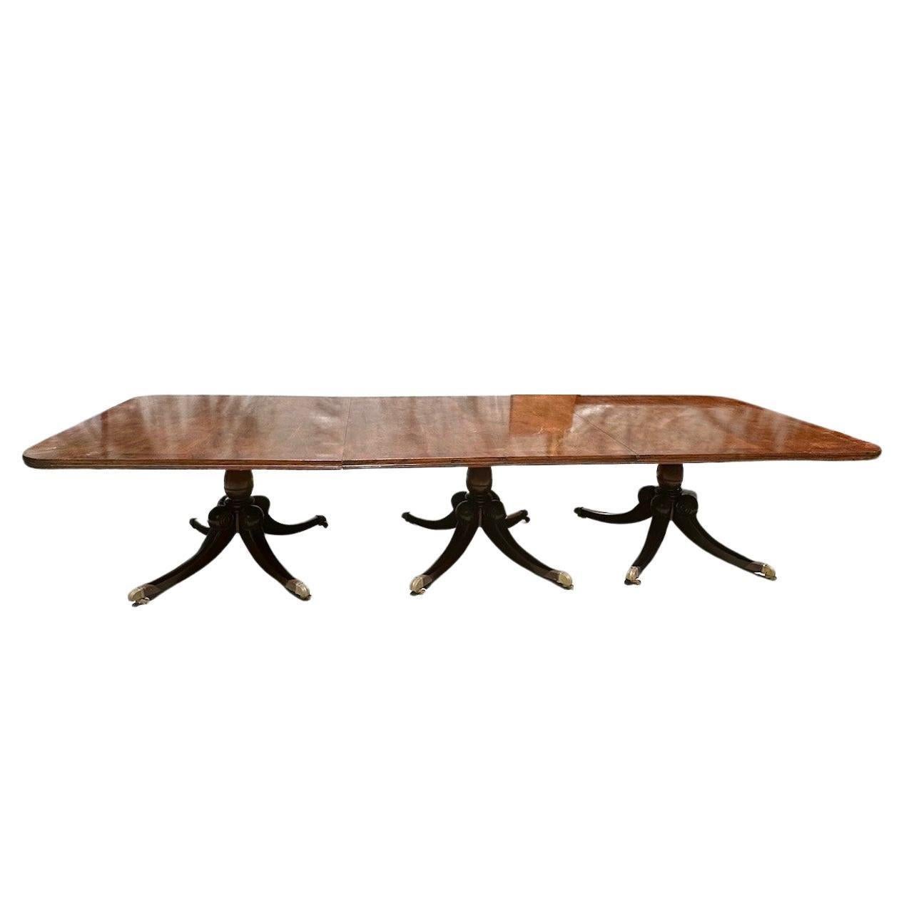 Large English Georgian Mahogany Triple Pedestal Extension Dining Table

Exceptional English Georgian style mahogany pedestal extension dining table with two leaves. This very large fine quality table with beautiful figured mahogany, has a