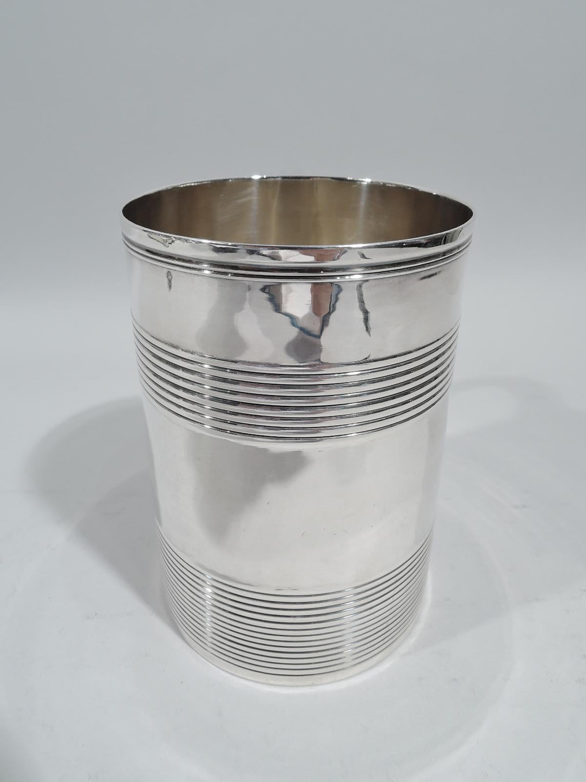 Large English Georgian sterling silver mug, 1795. Straight and upward tapering sides, capped double-scroll handle, and reeded bands. Fully marked including London assay stamp and worn maker’s stamp (possibly EB). Weight: 10.9 troy ounces.