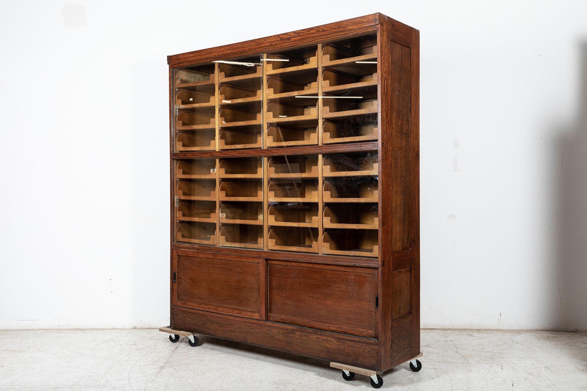 Circa 1930
Large English glazed oak Haberdashery Shop Fitters cabinet.
With 36 drawers, original sliding glass doors and hardware.
(1 section/Piece)
W177 x D50 x H198 cm
Inner drawer size W40xD40xH13cm.
 