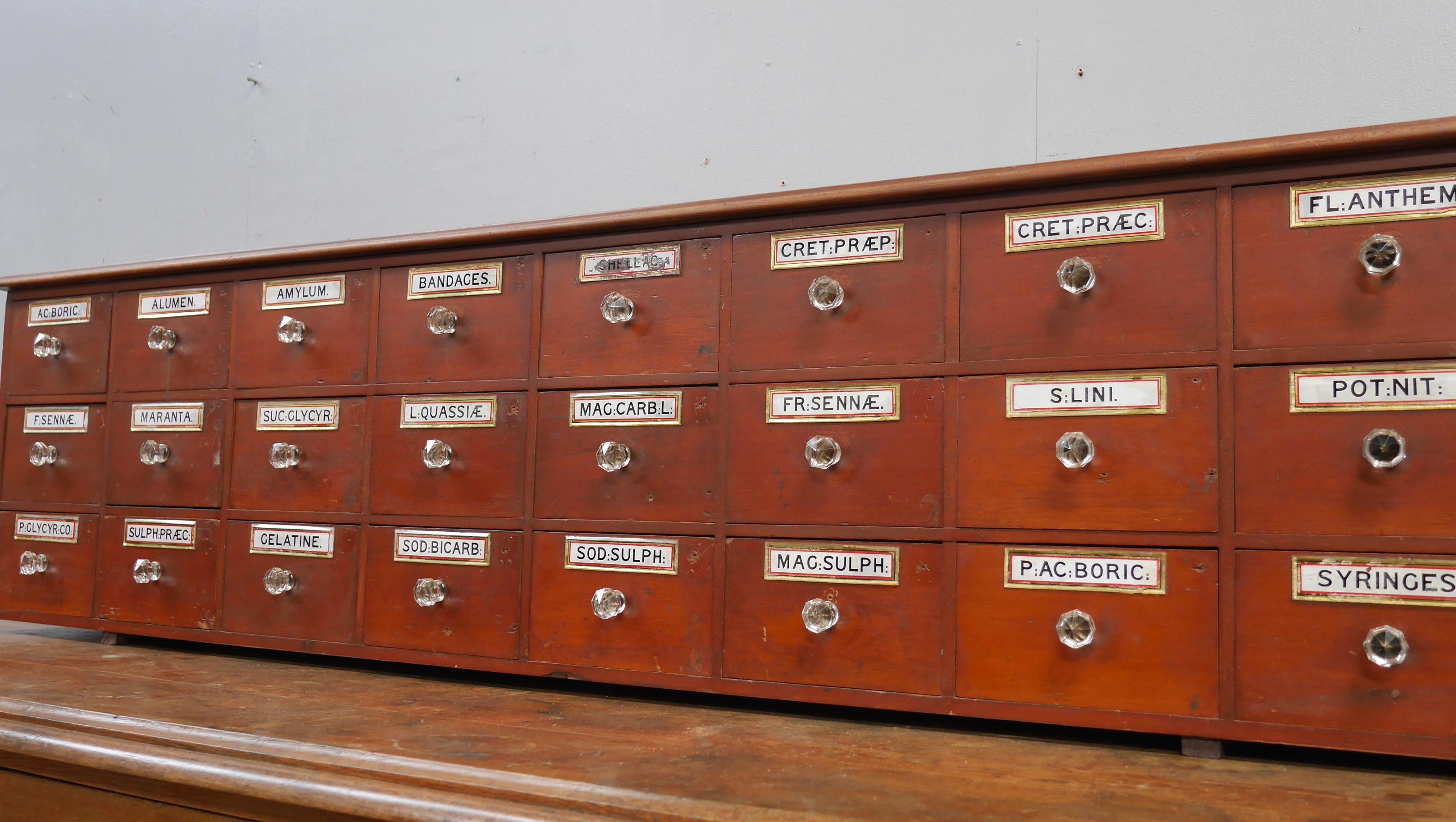 A bank of Late Victorian mahogany apothecary drawers.
A fantastic bank of antique pharmacy drawers od good scale with reverse-painted & gilded, bevelled glass labels to the drawer fronts & all original faceted glass handles.
With a good depth of