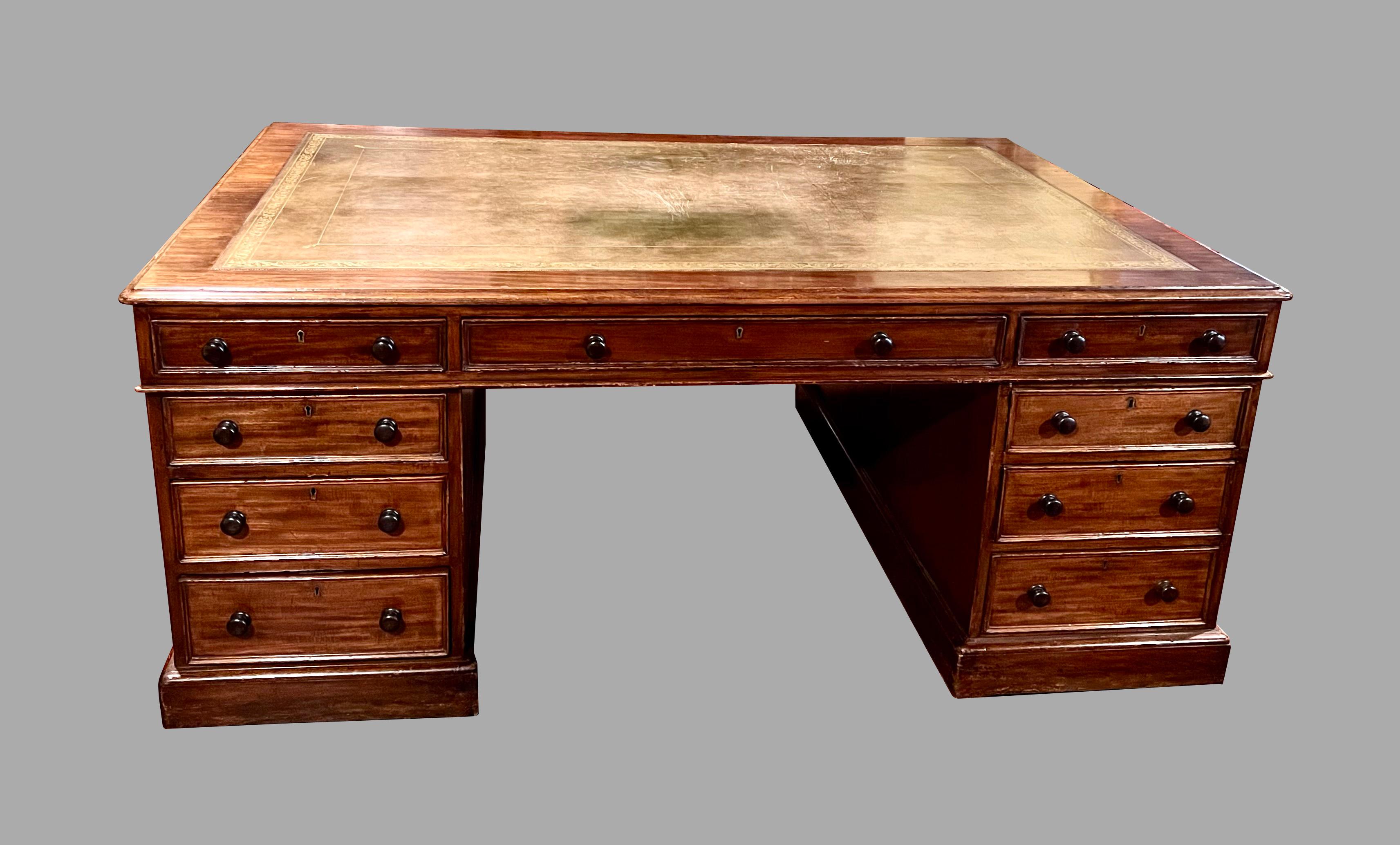 A good quality English Georgian style partners desk of typical form, the brown gilt-tooled leather top above 3 frieze drawers supported by 2 pedestals each with 3 graduated drawers all supported on a plinth base supported on later casters. The