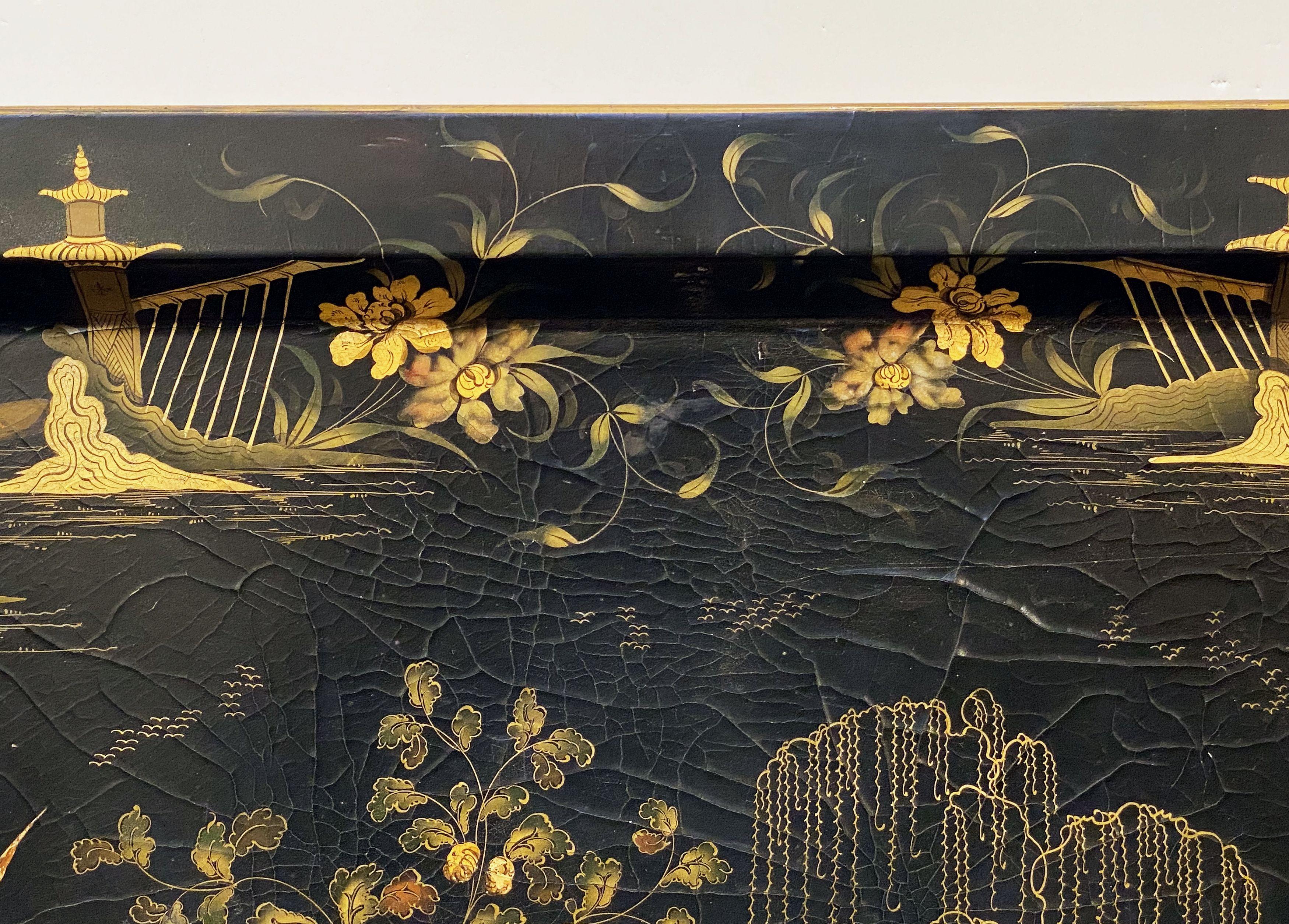 A fine large English lacquered papier-mâché tray from the Aesthetic Movement period, featuring a decorative chinoserie painting of stylized Asian figures, pagodas, and a garden bridge. Measures: (H 23 3/4 x W 30 1/4).