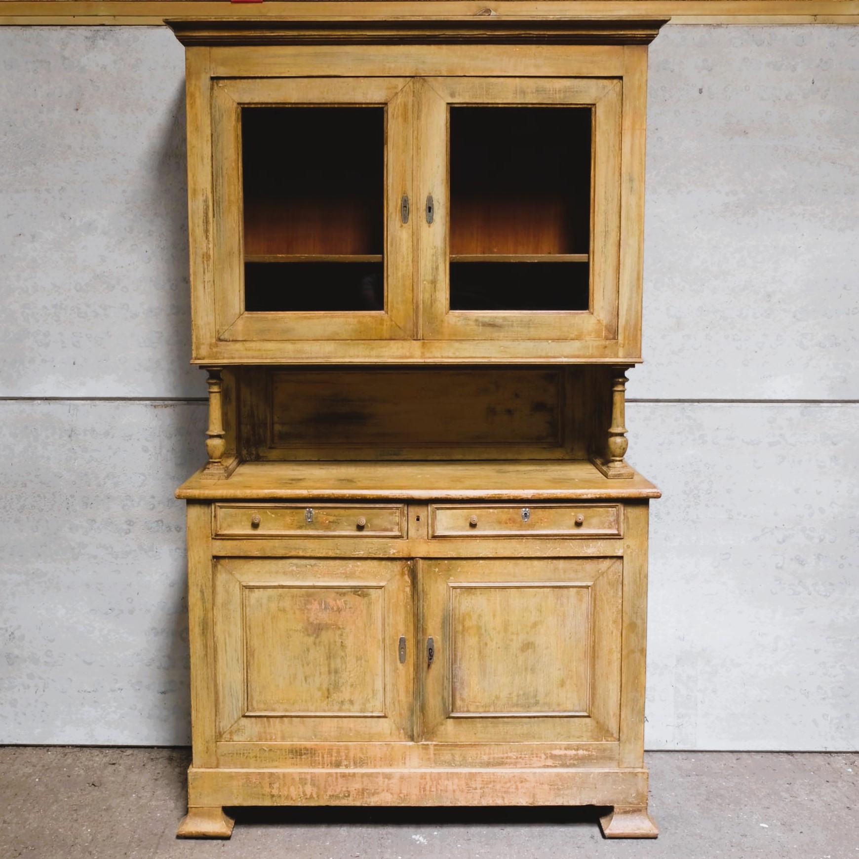 A large pine English dresser with glazed cupboards above, over a gallery shelf with turned supports, over a base comprising two drawers and large two door hinged cupboard, with original keys. Purchased by the previous owner from Petersham Nurseries.