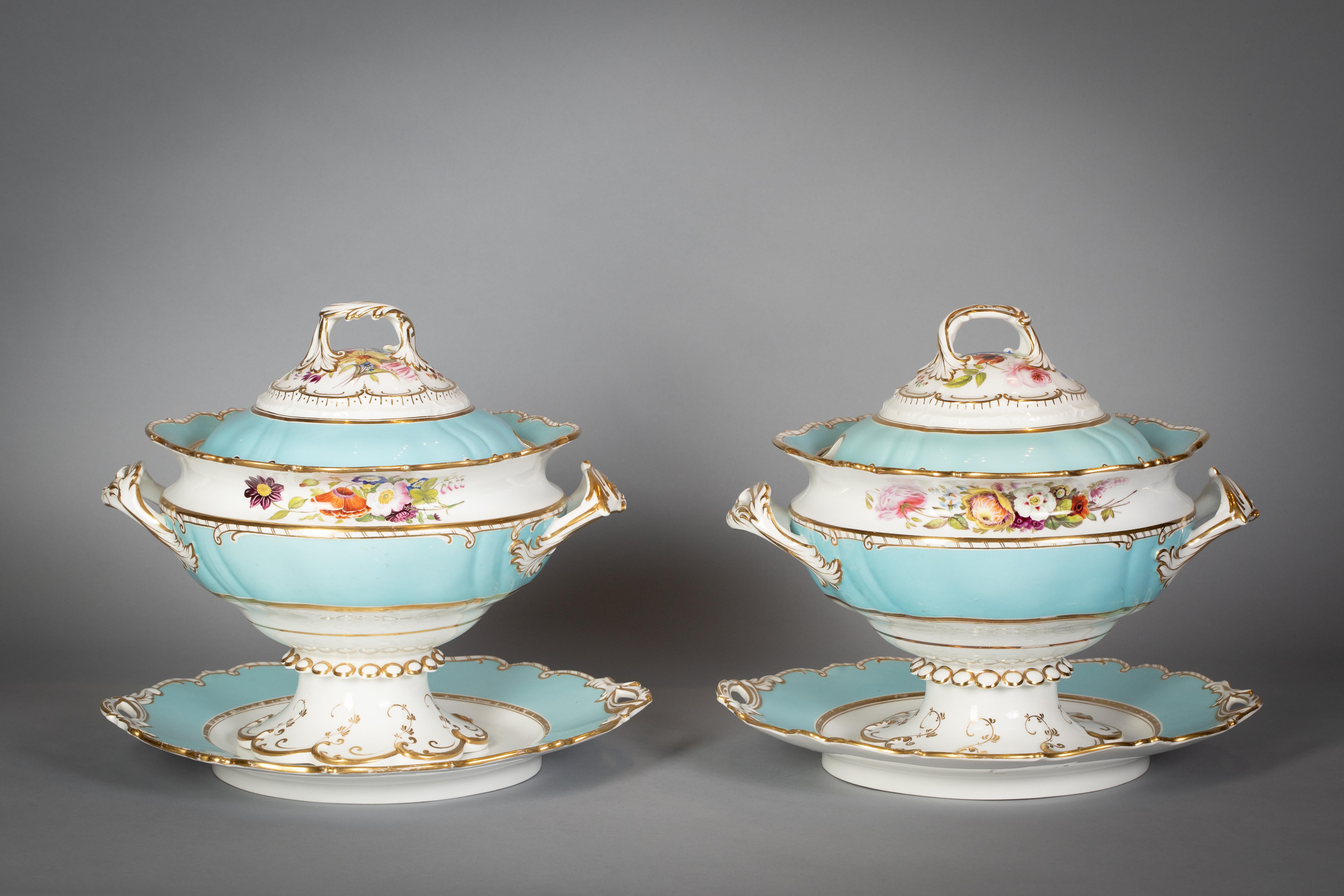 With a soft turquoise ground, painted with a fine spray of flowers, with gilt scroll and dash borders. Comprising pair of covered tureens and stands, pair of vegetable tureens, well and tree platter, 9 soup plates, 57 dinner plates, 3 platters.