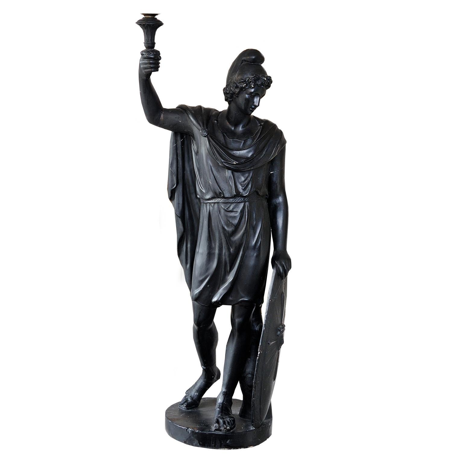 This is a large and striking English Regency faux bronze plaster statue holding a shield and candle sconce, depicting the Greek mythological figure Paris, also known as Alexander (