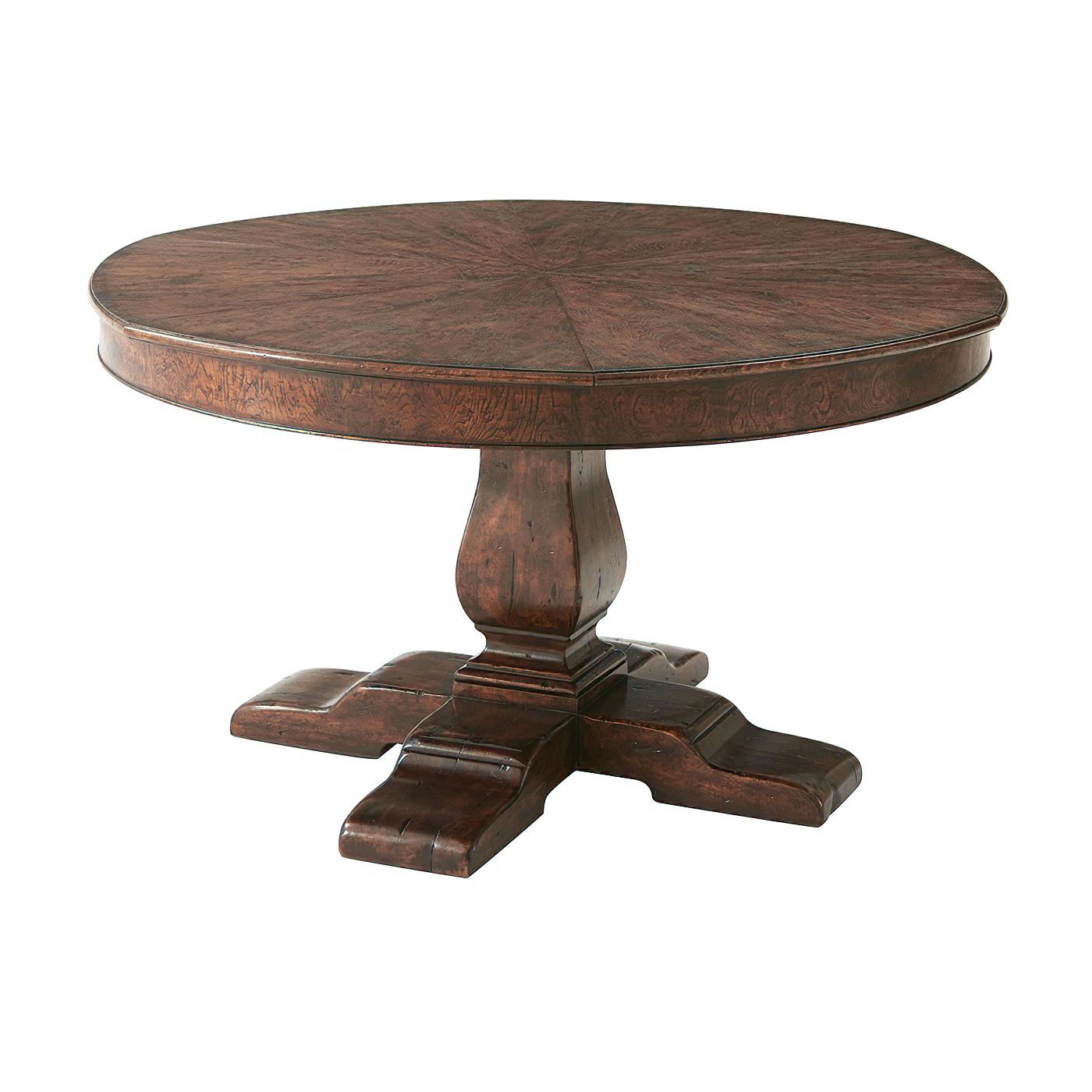 A reclaimed oak and chestnut burl restored circular extending dining table, the segmented top opening to reveal six self-storing fold-out leaves above a plain frieze, on a vase column support and crossover refectory feet.

Open Dimensions: 72