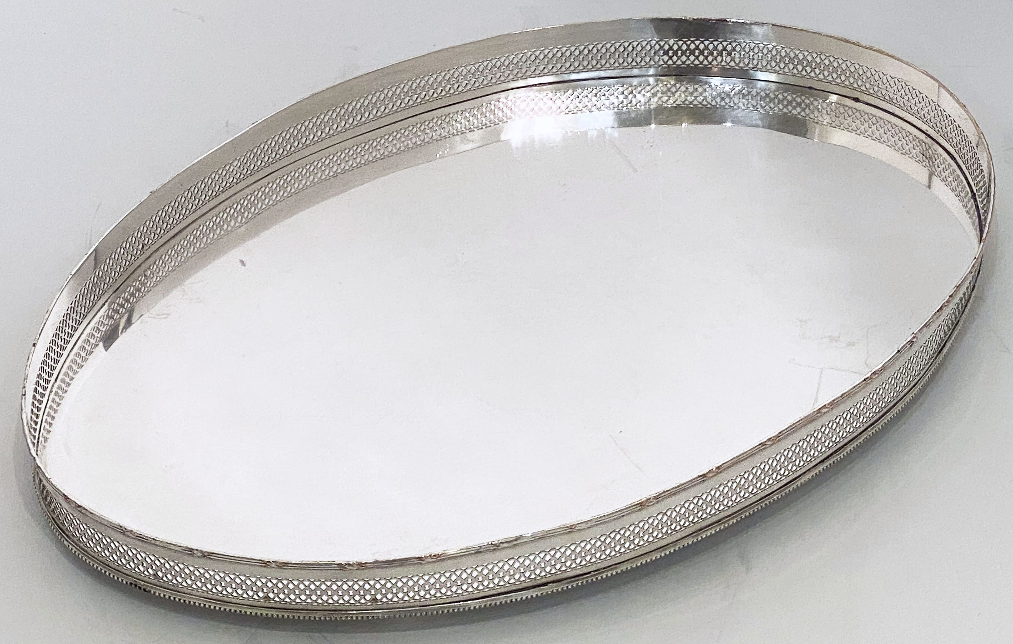 A handsome large English oval gallery serving or drinks tray (or platter) of fine Sheffield plate silver with pierced serpentine gallery around the circumference.

Dimensions: Gallery H 2 1/2 inches x W 24 inches x D 16 inches.