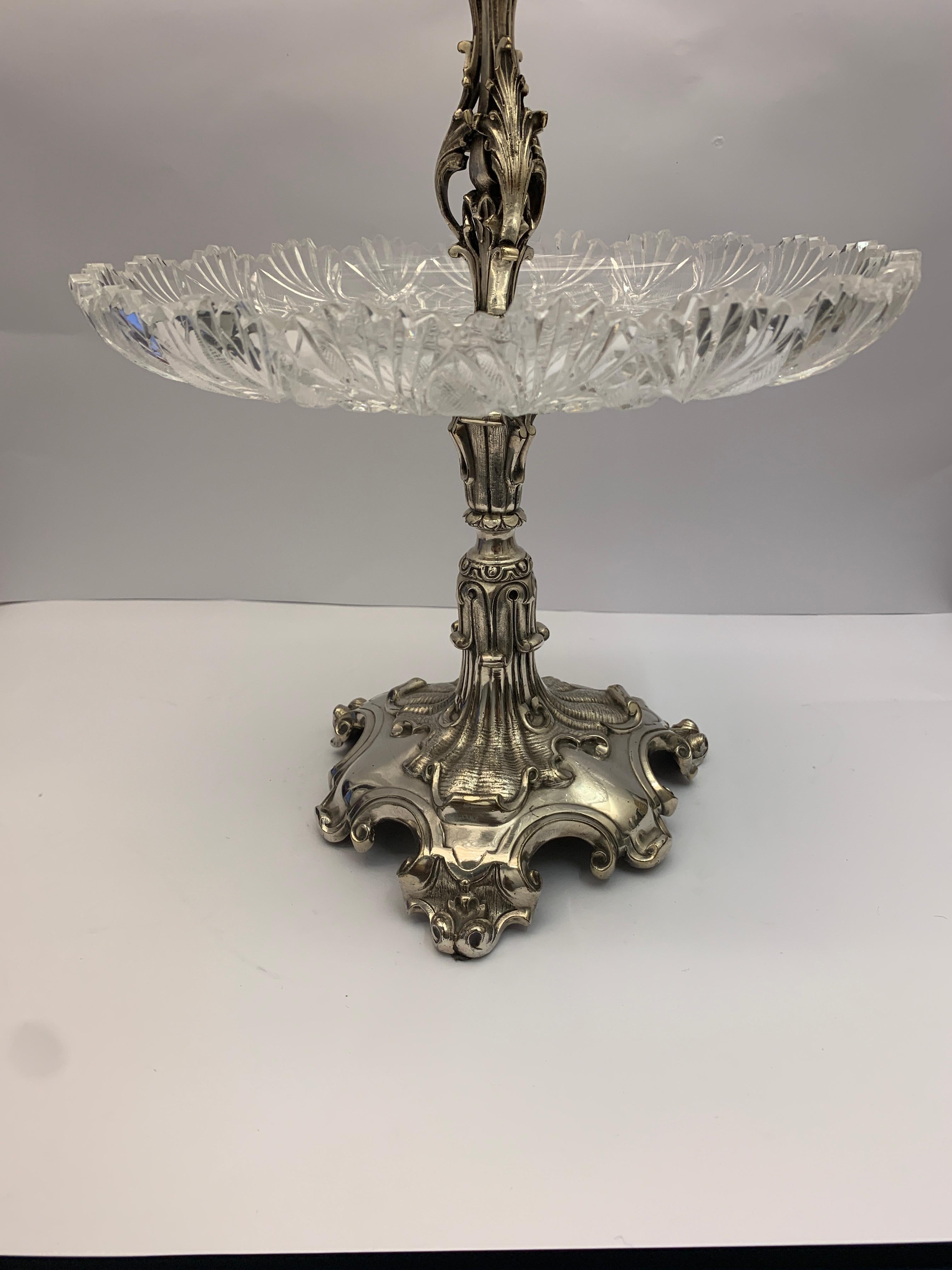 Large English silver plated cake stand with 2 glass stands. Intricately decorated throughout.
