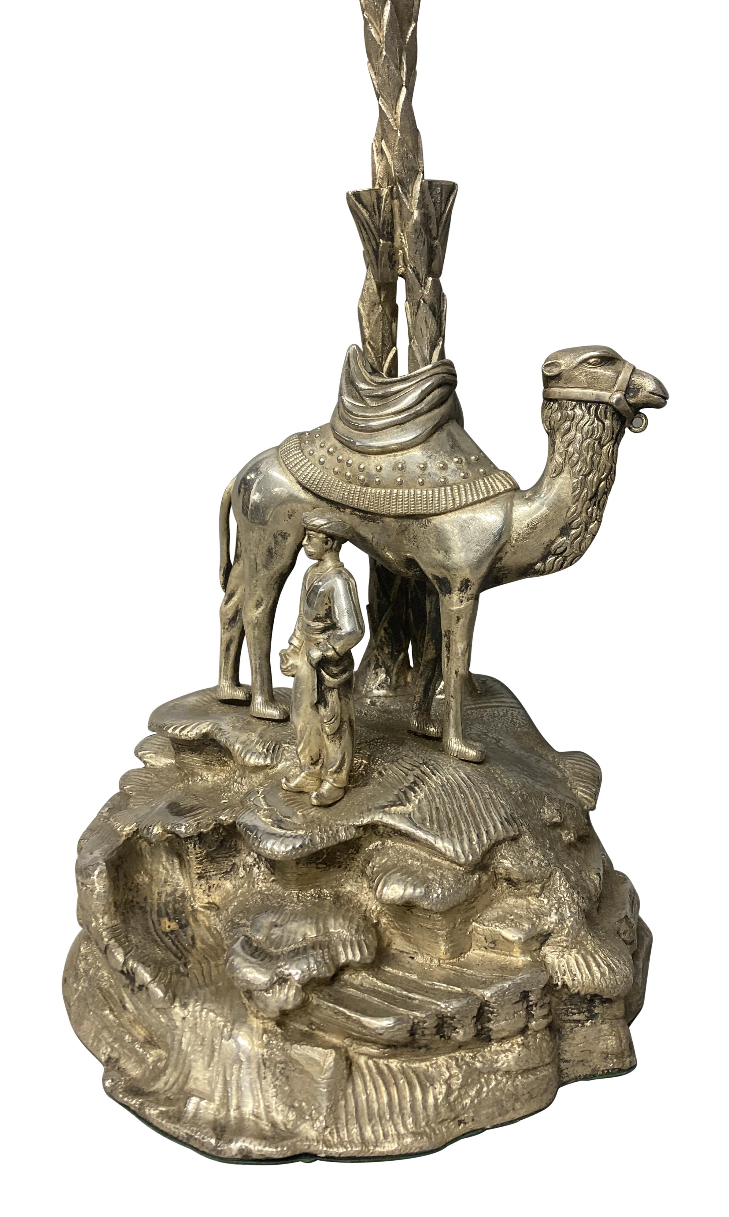 A large English silver-plated palm tree lamp, with a camel and figure at the foot of the tree. Well cast with good patina, probably by Elkington.