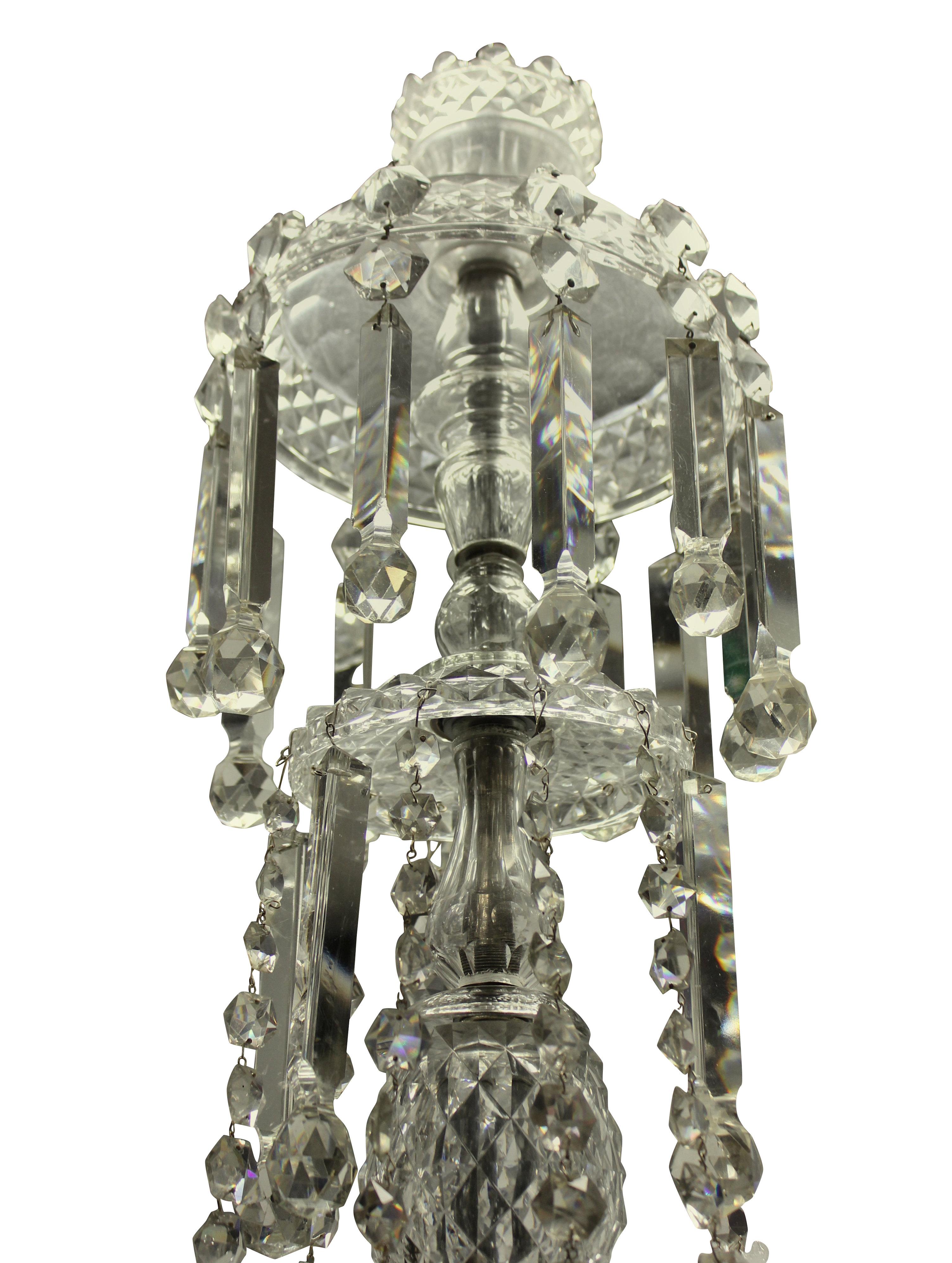 A large English cut glass chandelier of fine quality, comprising eight lower and eight upper arms. The chandelier is profusely hand cut throughout in the pineapple design and hung with pendants, swags and decorations.