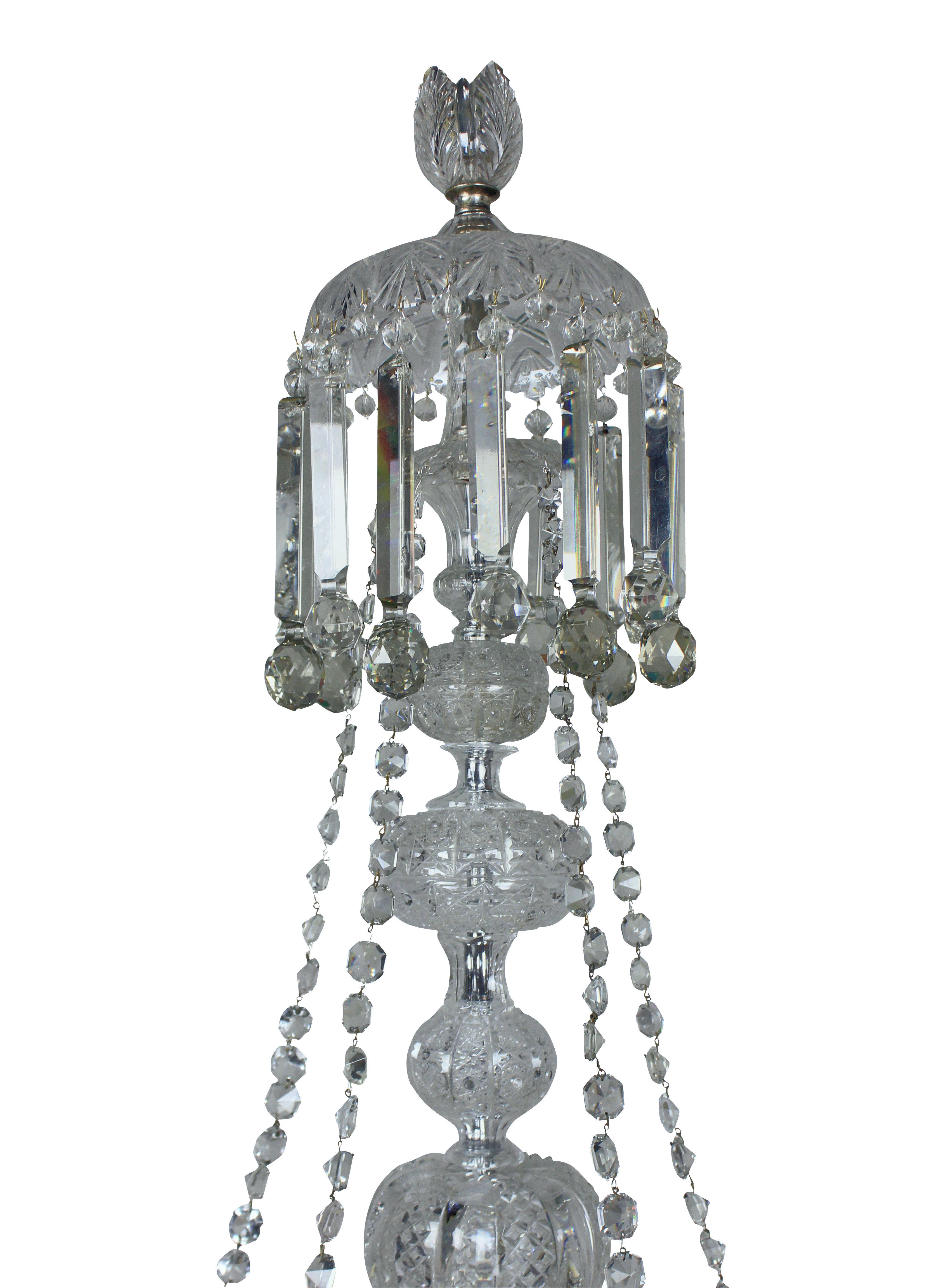 A large English ten light Victorian cut glass chandelier of fine quality. Formerly a gasolier, with hollow glass arms arranged in two tiers and hung throughout with profusely hand cut prisms and swags.