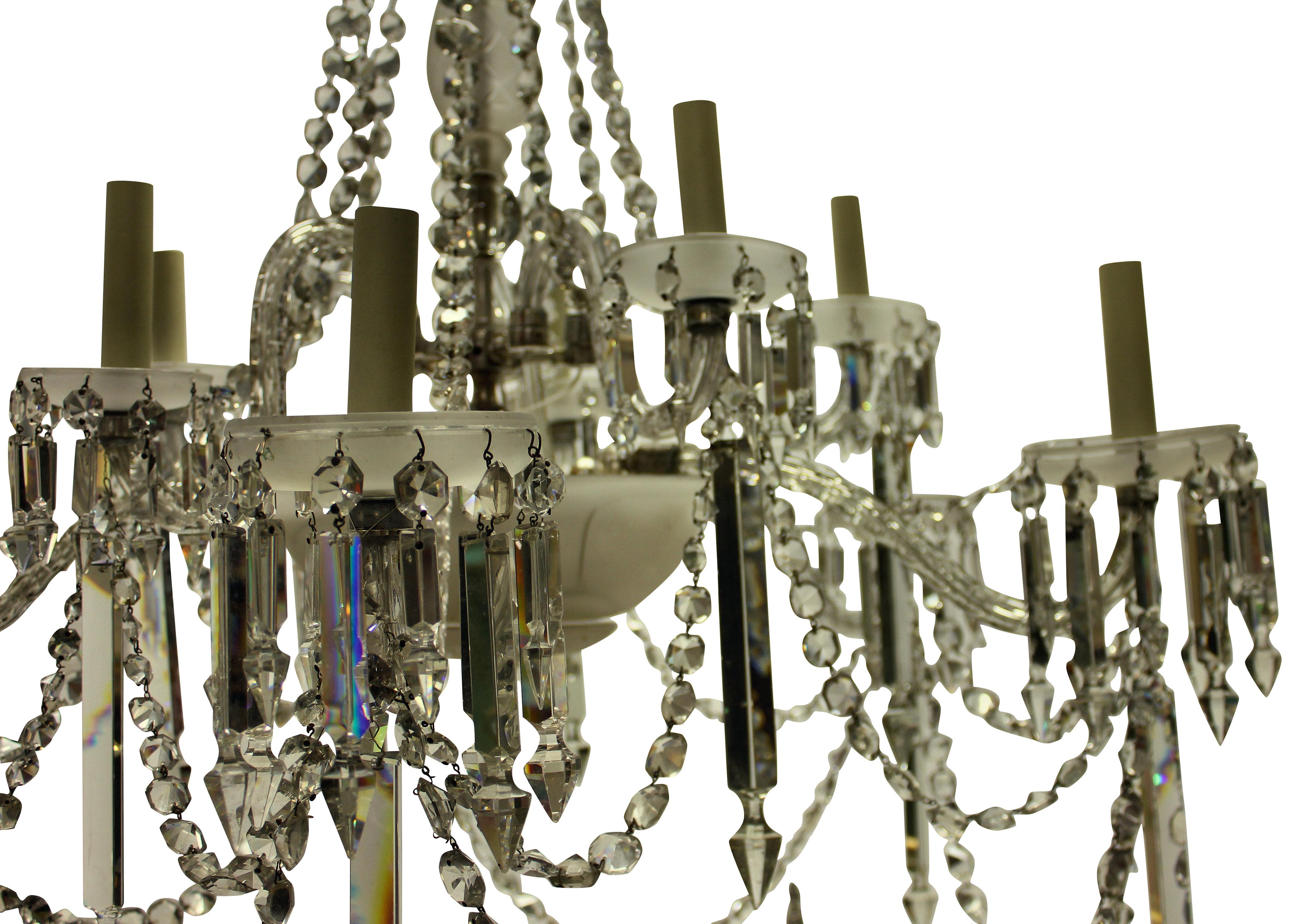 A large English cut and frosted glass Osler chandelier of good quality. Formerly a gasolier, with five up-swept arms and five down-swept arms. The central receiver dish and pans in frosted glass. Hung throughout with prisms and chains.