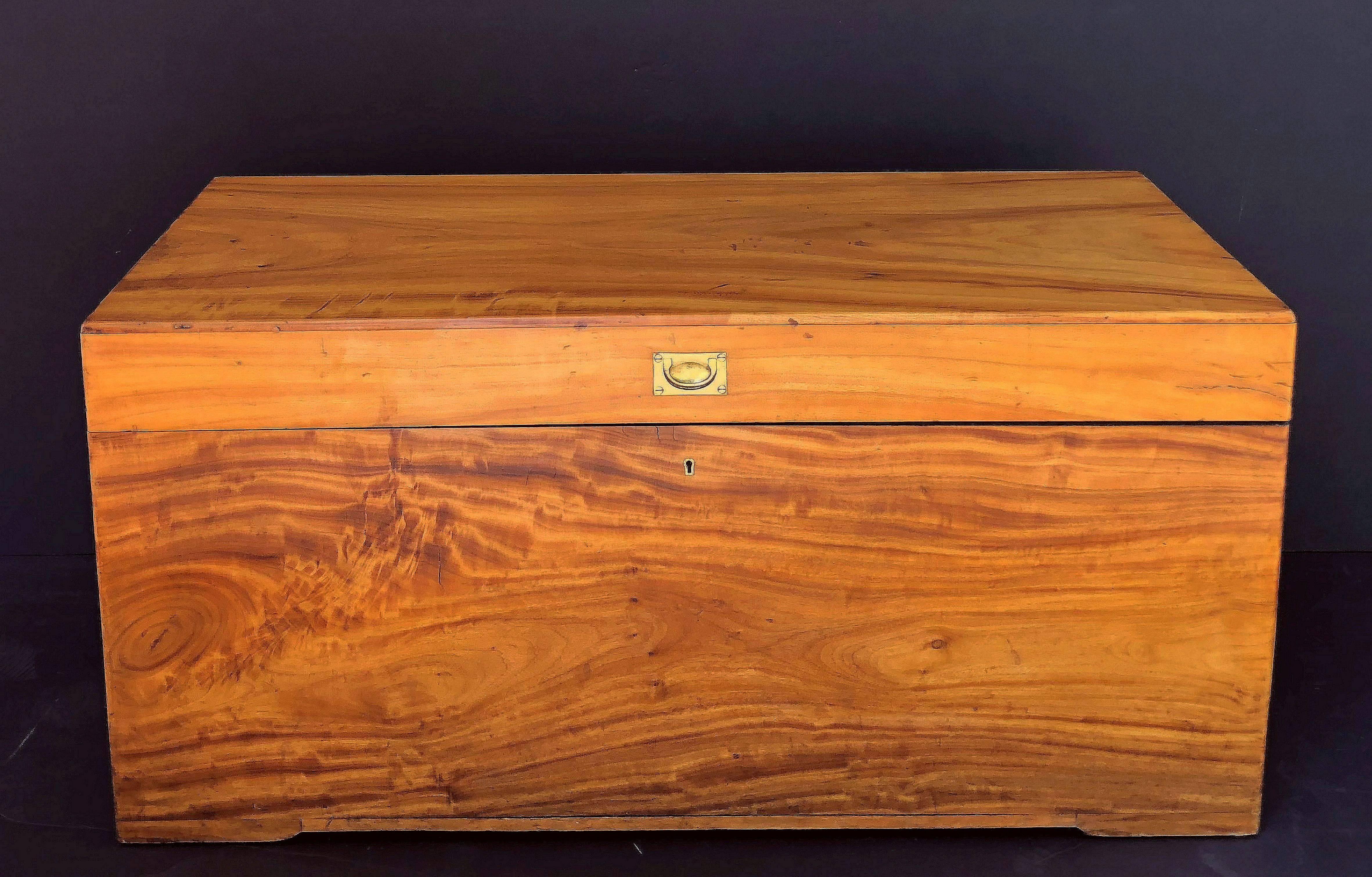 A handsome large British officer's rectangular trunk or chest (coffer) of camphor wood, manufactured for an officer to carry his kit on campaign. 
With original recessed brass front latch, brass escutcheon, and brass carrying handles to each side.