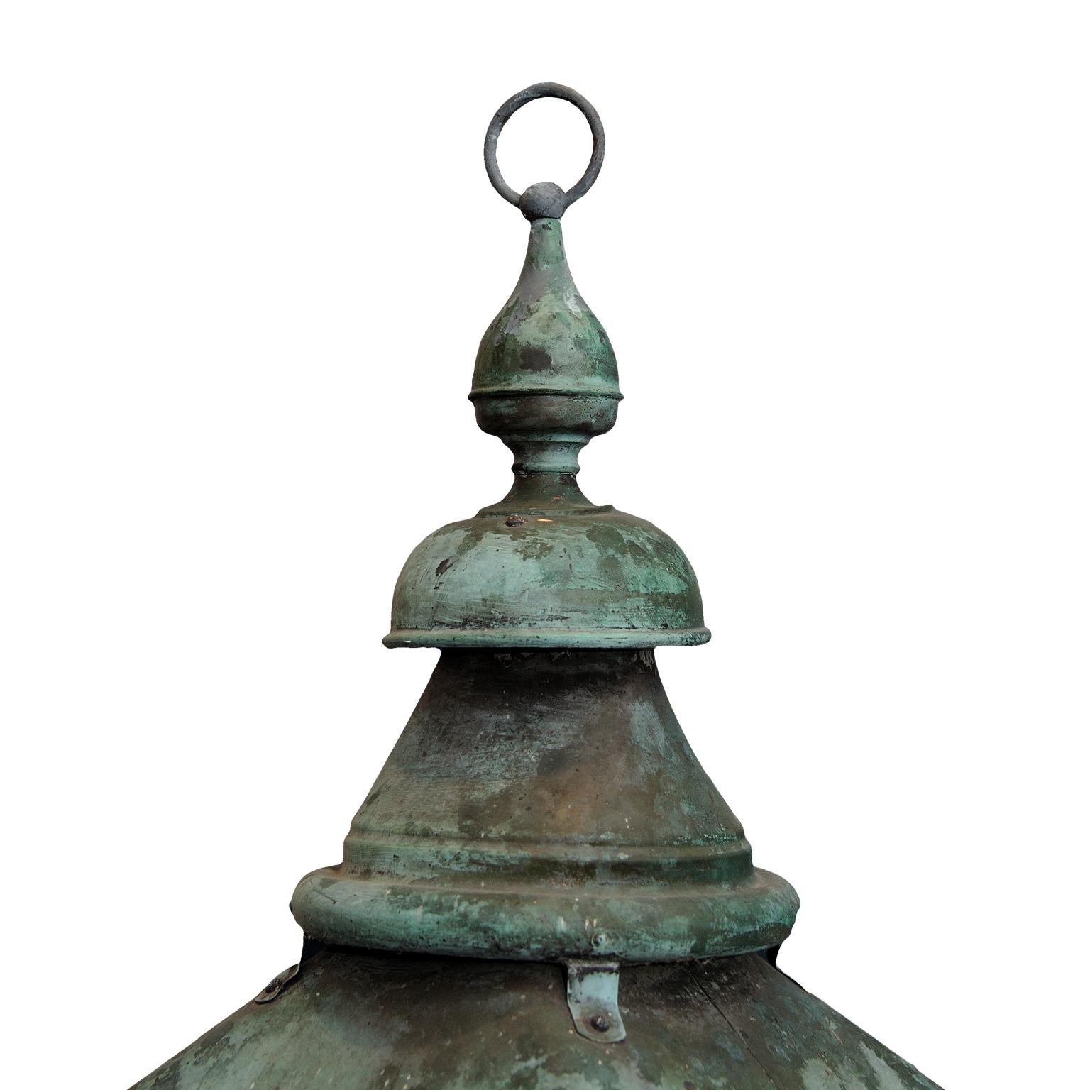 This is a very stylish large English verdigris copper hanging Lantern, now converted to electricity, suitable for interior or exterior use. Complete with lions paw feet, circa 1860.
