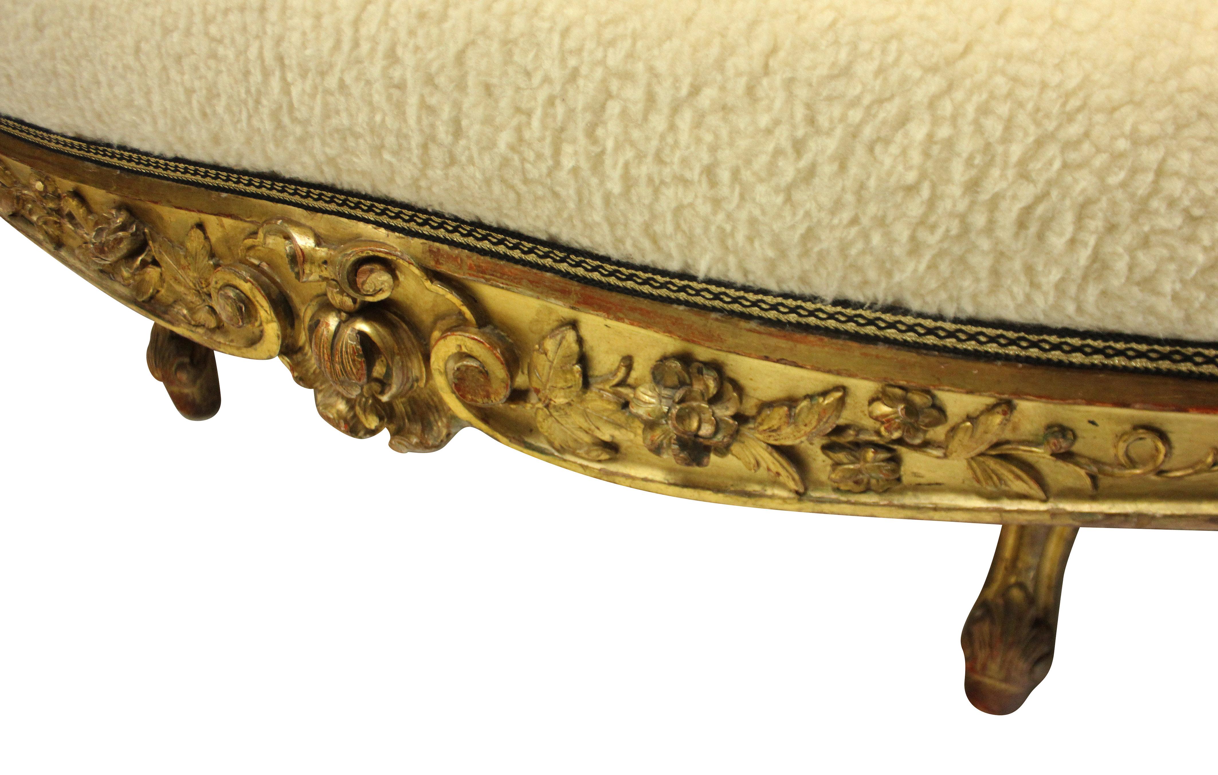 A large English carved and water gilded settee of fine quality, with shell crest, scrolled corners and decorated with English roses and foliage throughout. Newly upholstered in faux lambswool with a black and gold trim.