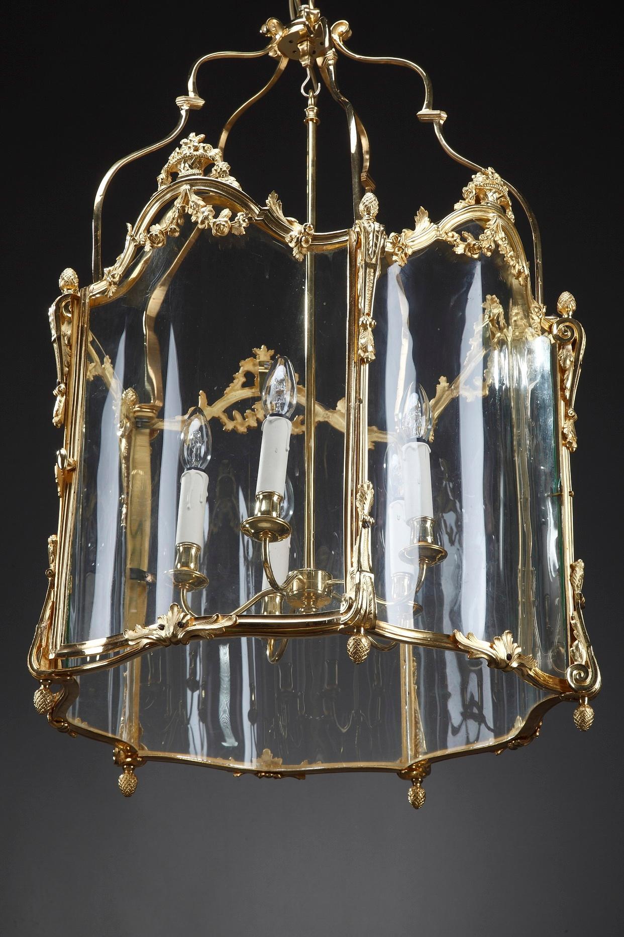 Monumental 5-light ormolu entrance hall lantern beautifully designed in Louis XV style. The polylobed mounts are finely decorated with flowery baskets, acanthus leaves, foliated console and pine cone finial. With its original curved glasses. This