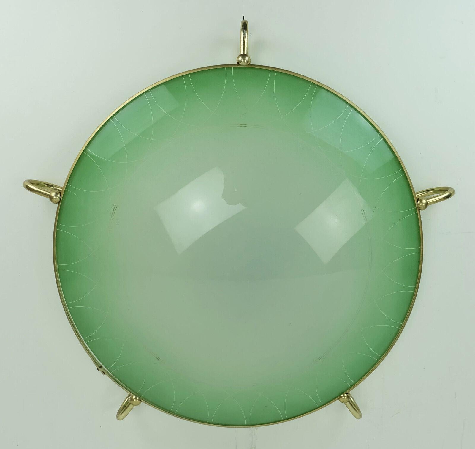 Very beautiful 1950s vintage ceiling light by Erco-Leuchten. Model No. 70 in a rare version in green glass with a graphic pattern (the version with a plastic shade is more common). The frame is made of brass-colored anodized light metal, the center