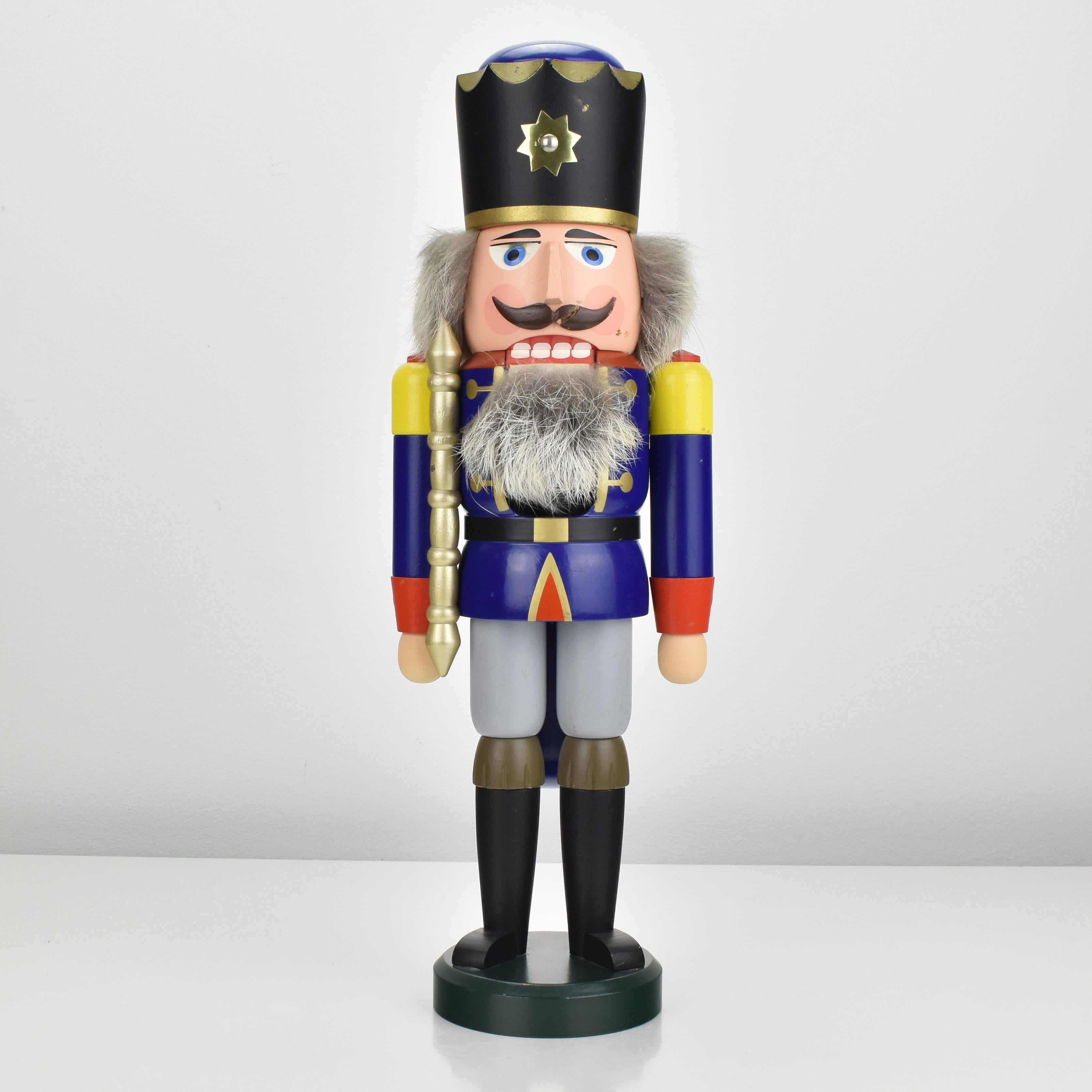 A vintage nutcracker from the Erzgebirge region, in shape of a king made of turned wood and painted in vibrant colors, dating back to the 1970s.
This large nutcracker is decorated with real fur and showcases the intricate craftsmanship and