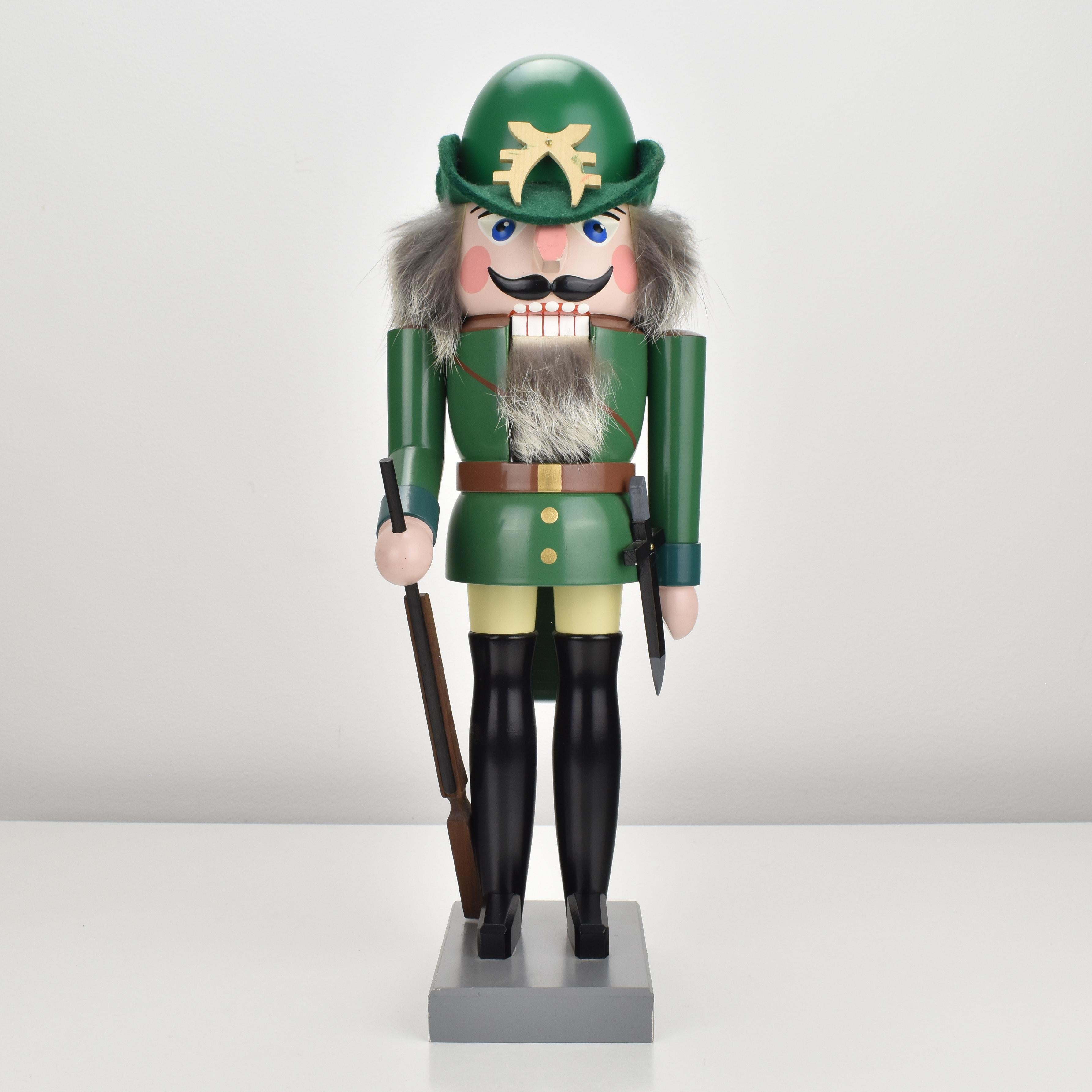 A vintage nutcracker from the Erzgebirge region, in shape of a hunter made of turned wood and painted in vibrant colors, dating back to the 1970s. This piece is made by the famous manufacturer Füchtner and is marked on the base as also handsigned by