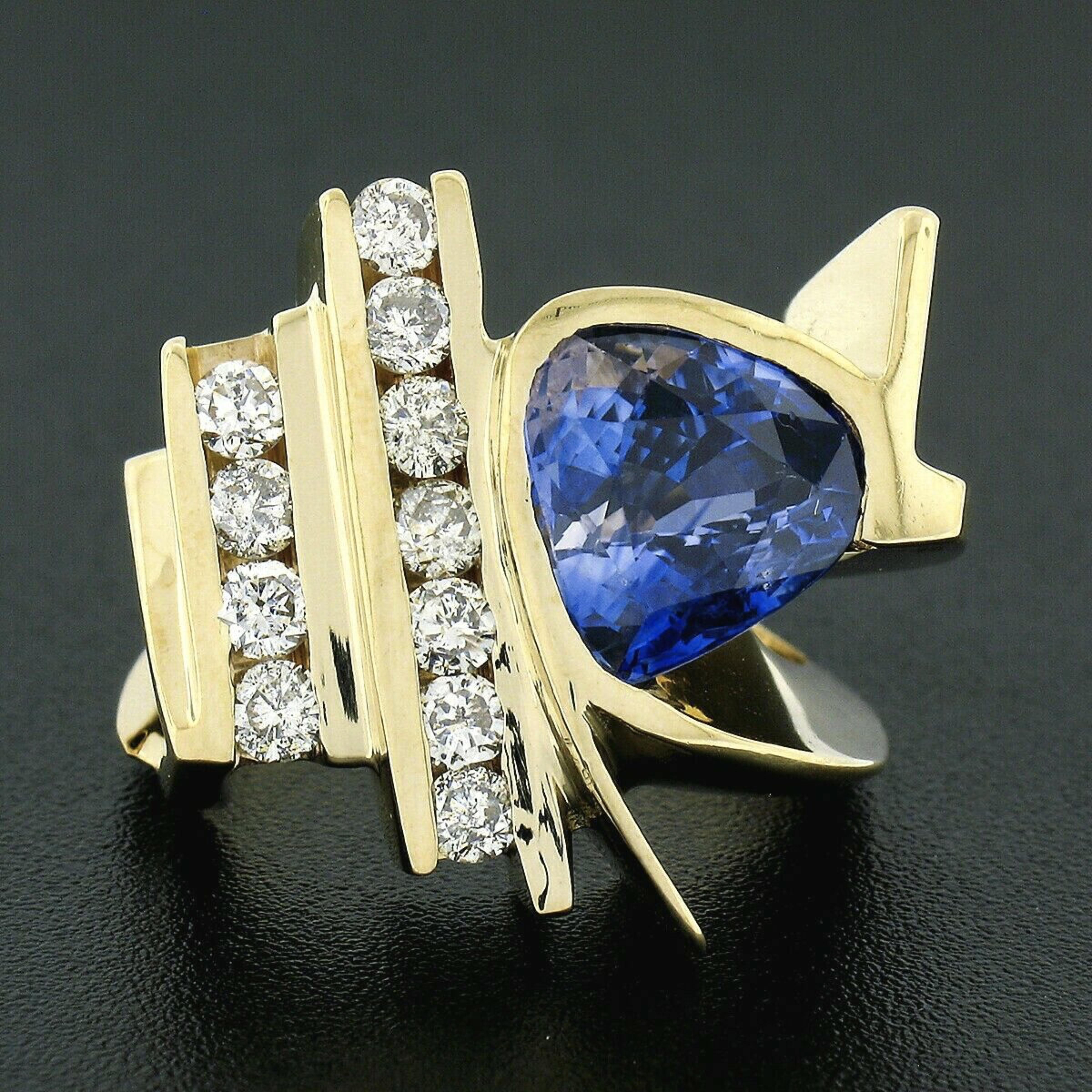 Here we have a magnificent cocktail ring crafted in solid 14k yellow gold. This large ring features a trillion cut tanzanite that is elegantly channel set and displays a gorgeous violetish-blue color that brings a very attractive and desirable look