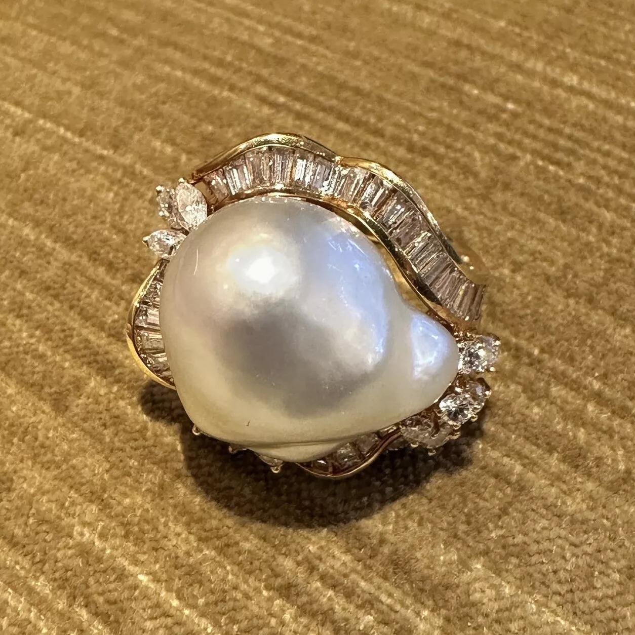 Large Estate Baroque Pearl and Diamond Ring in 18k Yellow Gold 

Baroque Pearl and Diamond Ring features a Large Baroque Pearl measuring approximately 18mm by 21mm with Silver overtones accented with Round, Baguette, and Marquise Diamonds, all set