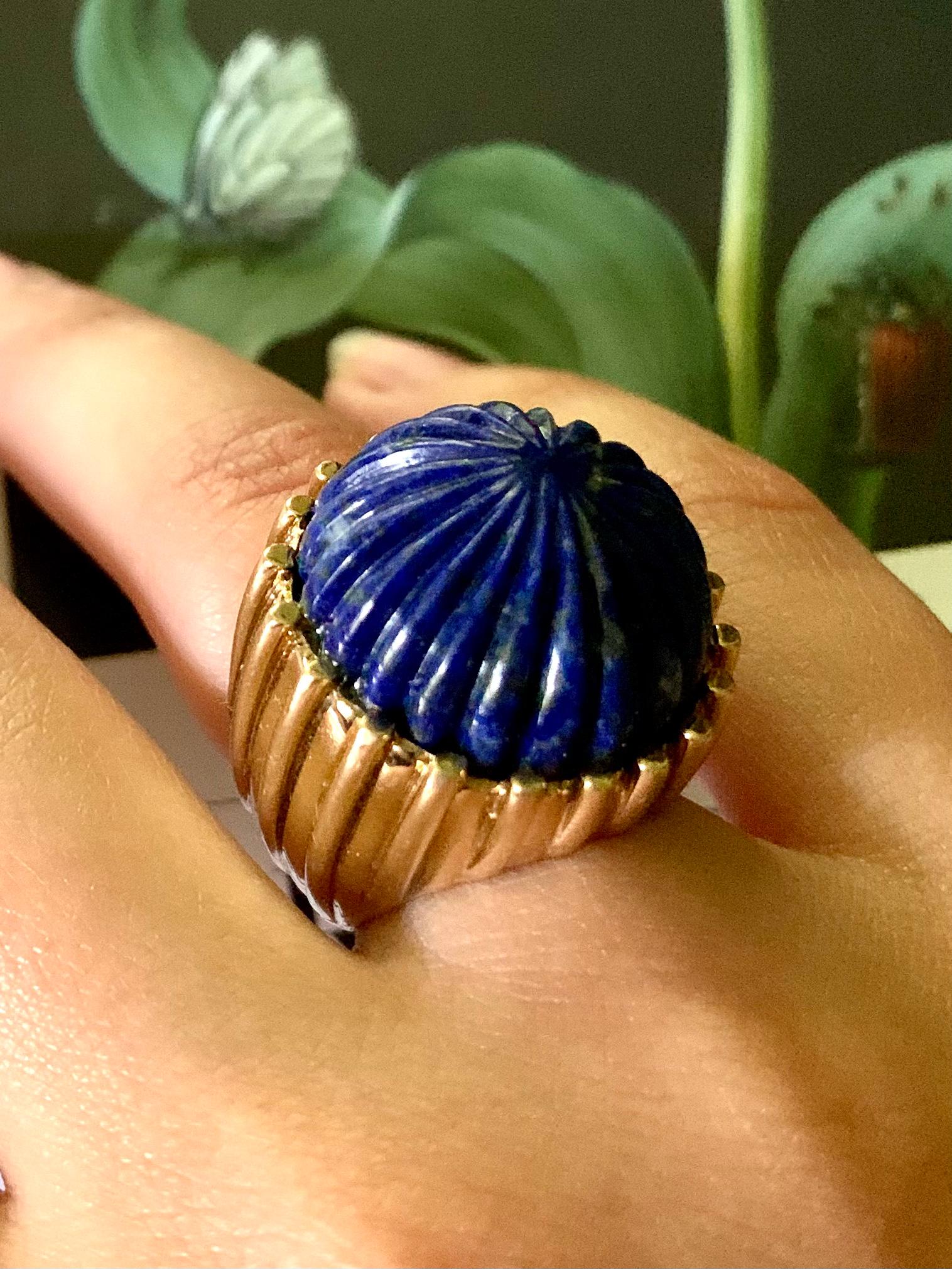 Impressive Classical Roman style carved Lapis Lazuli fluted 14K yellow gold statement ring. The carved Lapis Lazuli measuring 20mm in diameter, set in a substantial fluted gold setting which complements the carved design. Well proportioned, fine