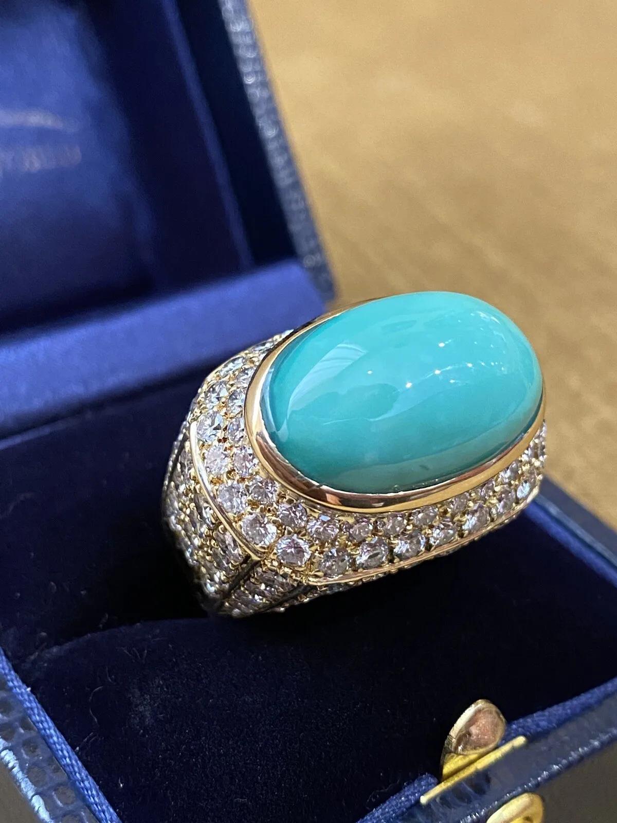 Large Pavé Diamond and Turquoise Dome Ring in 18k Yellow Gold

Estate Turquoise and Diamond Ring features a large Oval Turquoise Cabochon bezel set horizontally with a High Dome Setting and Round Brilliant Diamonds Pavé set in 18k Yellow