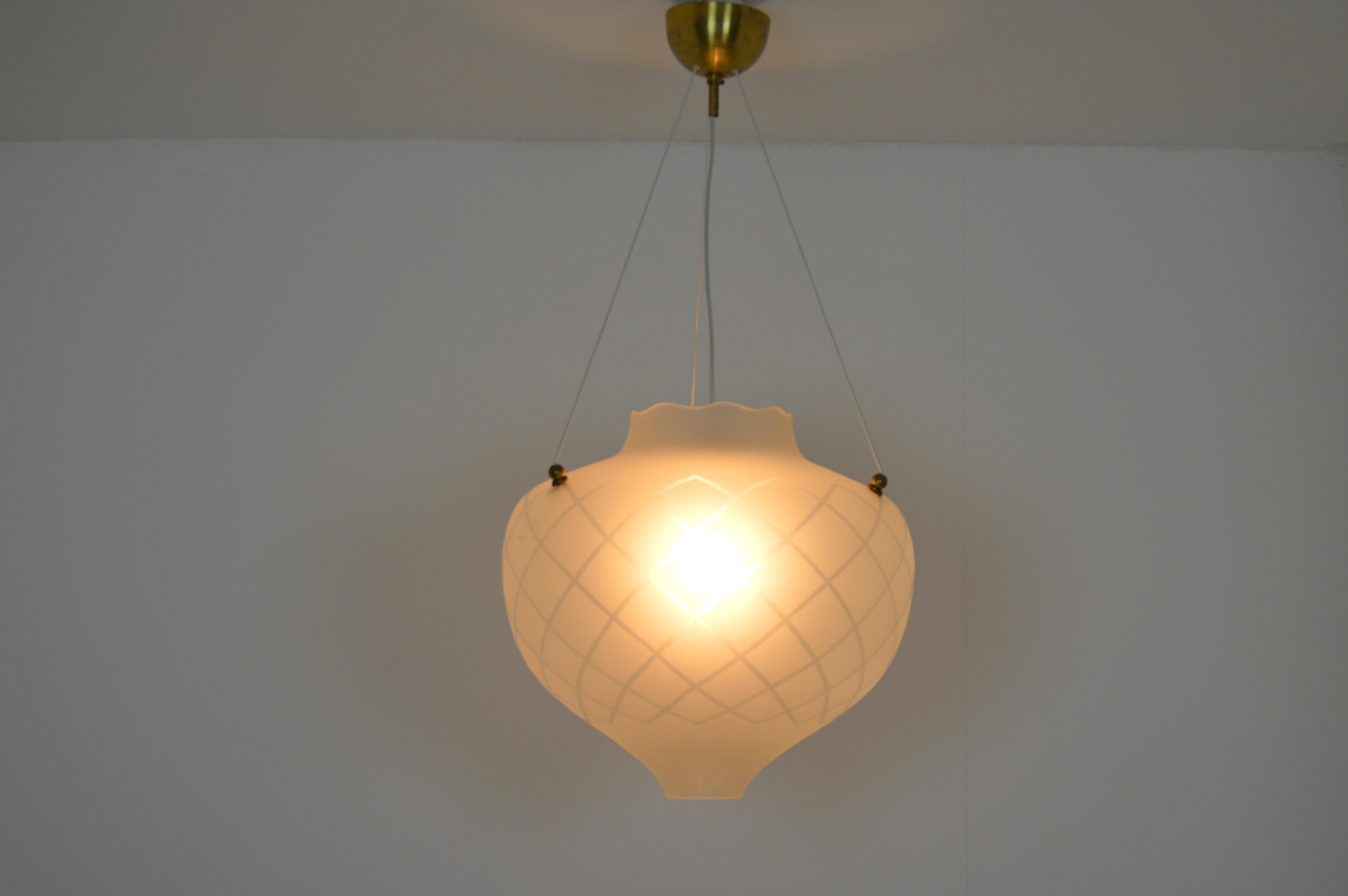 Swedish modern handmade glass pendant. Most likely produced by Orrefors, Sweden. 
Frosted glass with etched decoration.
It hangs in three wires and gives a majestic impression. It will be the center of the room.

Measures: Diameter 38cm