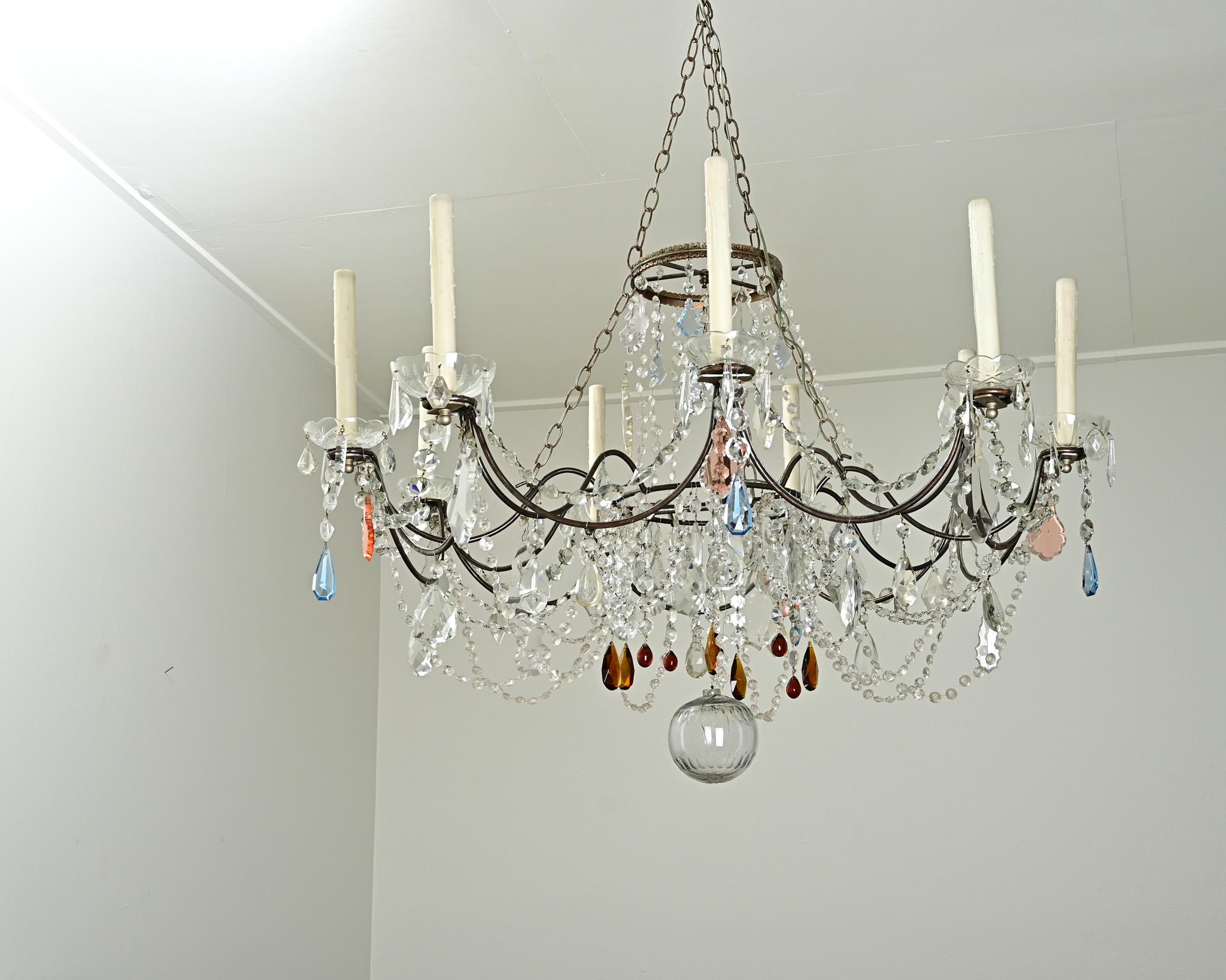 This massive chandelier was recently made by the owners of this shop. We had over 40 years of antique chandelier crystals in a box and other found metal parts that all came together to create this playful and whimsical light fixture. Each crystal