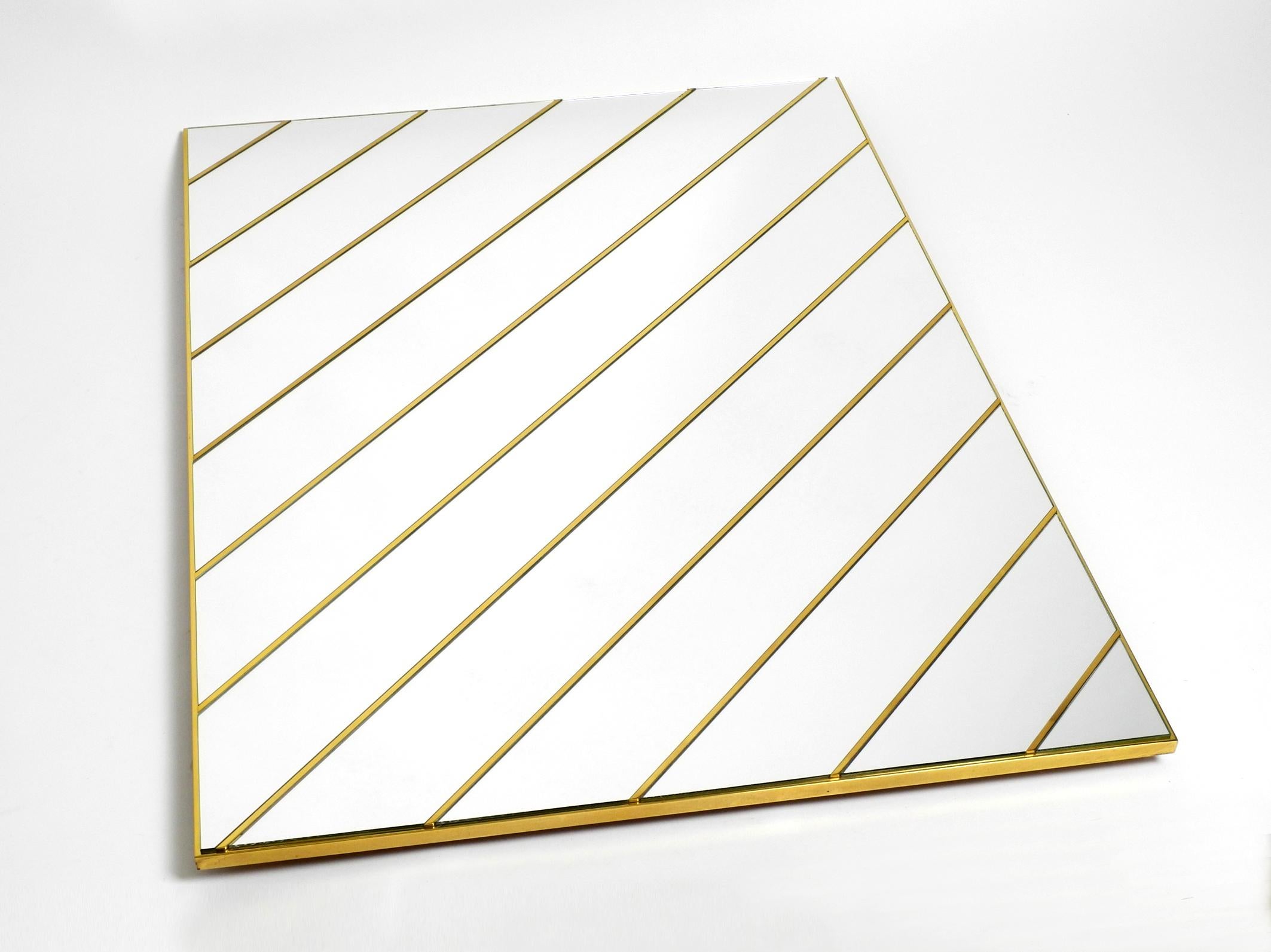 Large, exceptional 1970s brass wall mirror with single diagonal mirror stripes.
Great 1970s minimalist Rgency design. Very high quality and elegantly processed.
The complete frame and diagonal stripes are solid brass.
Very good condition with no