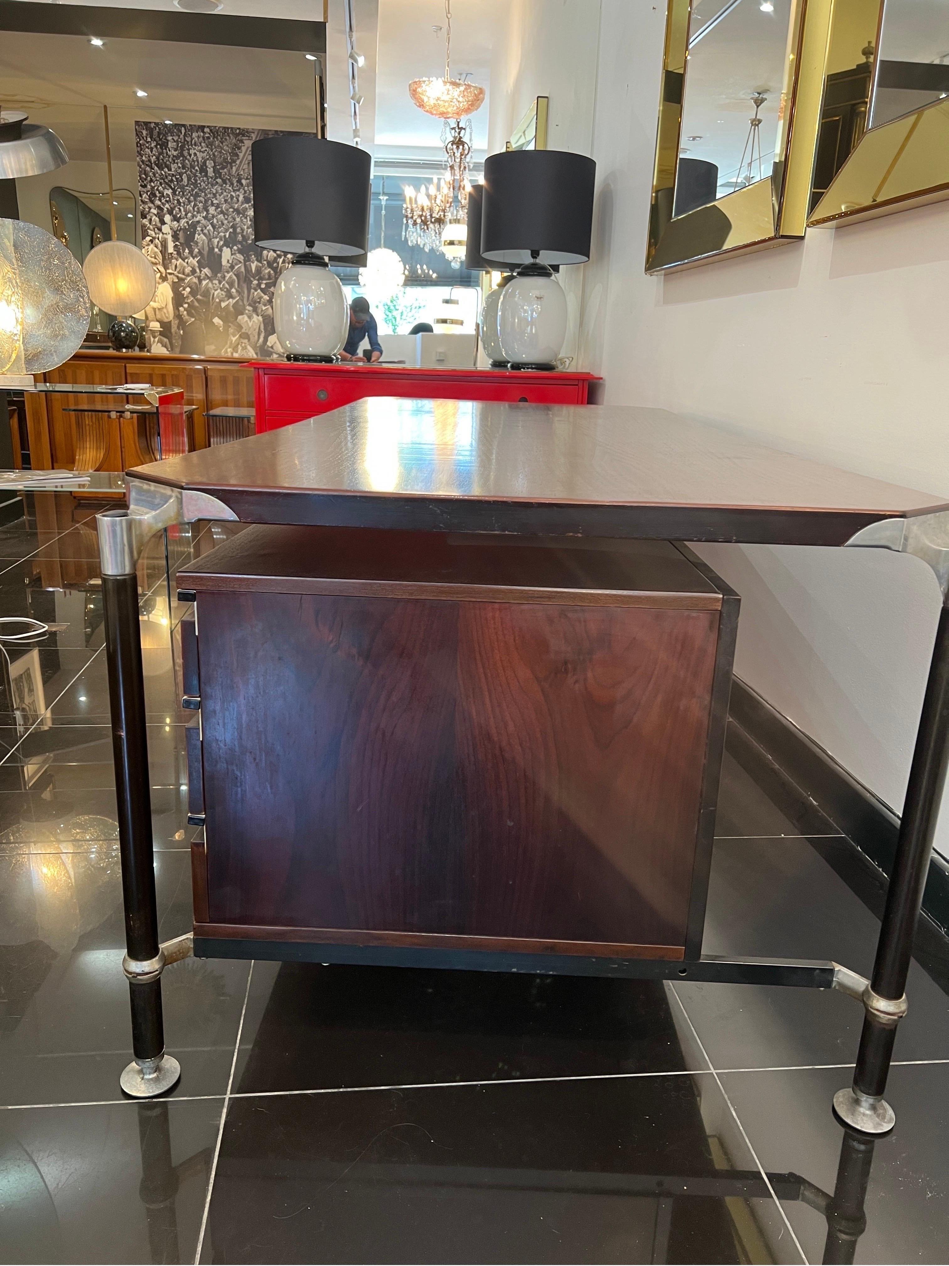 An extra large rosewood executive desk designed by ico Parisi for MIM Rome in 1962 . Structure made from lacquered steel with aluminium supports , there’re three floating drawers to the side with aluminium handles . The rear is a full size recessed