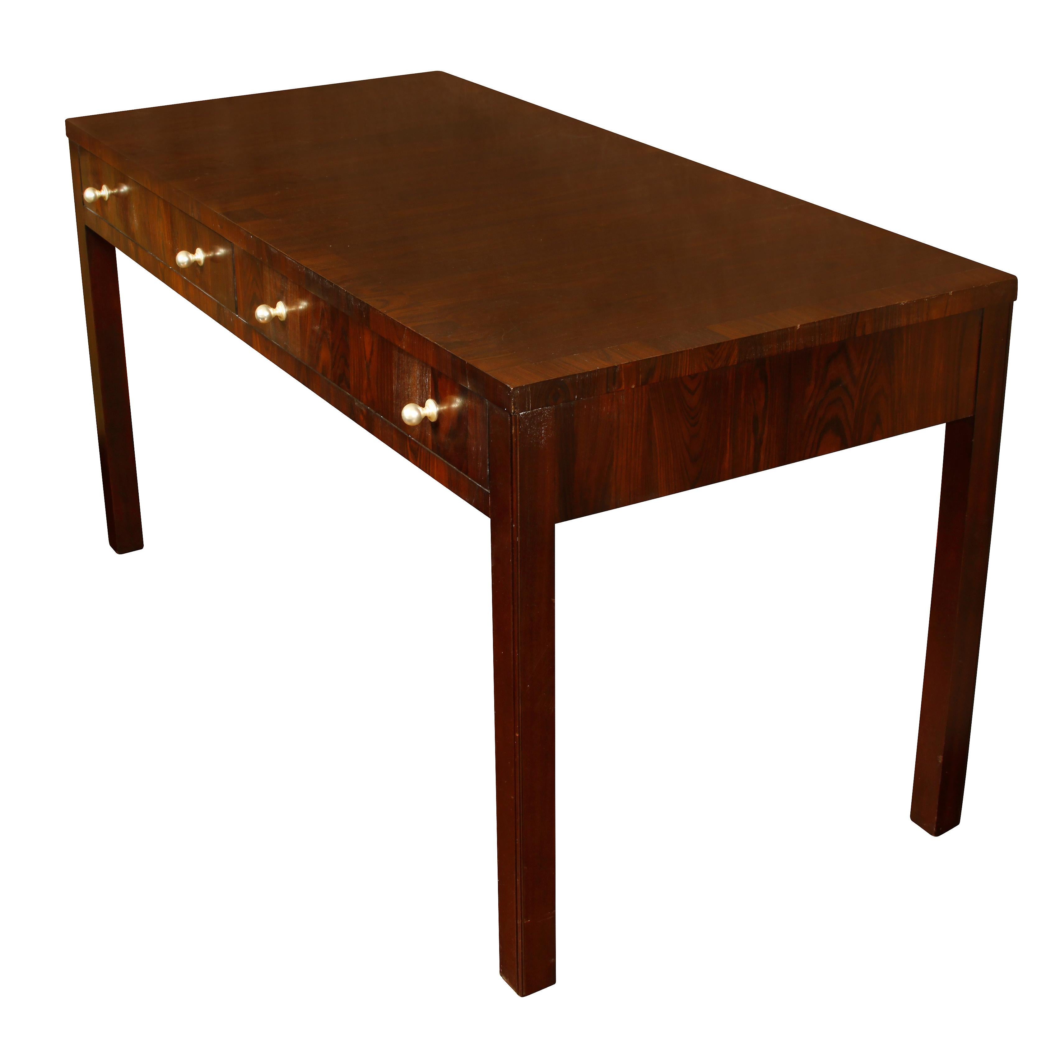 Large Parsons style desk made of exotic wood with round nickel drawer pulls.