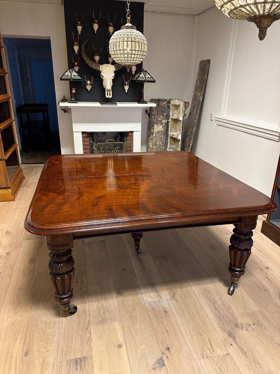Large impressive antique mahogany dining room table. Beautiful stylish leg and equipped with a 5th leg for extra stability.
The sliding system runs smoothly. The extra leaves allow the table to be set up in different lengths. The extra tops are not