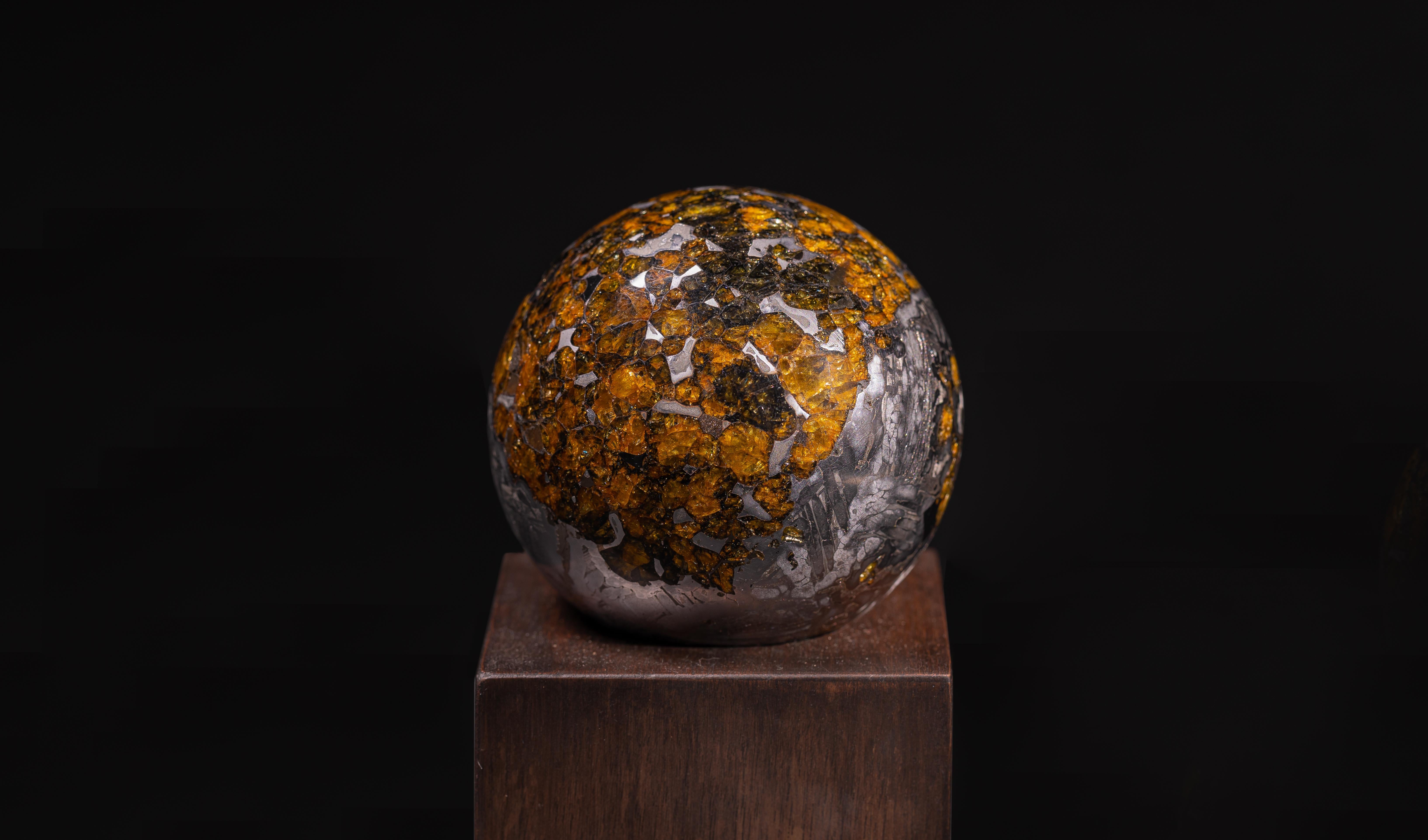 Seymchan Sphere.
Pallasite
1390 g

Comprising less than 0.2% of all meteorites, pallasites, made up of an iron-nickel matrix interwoven with amber-coloured olivine gemstones, are perhaps the most dazzling meteorites of all. This piece, extracted
