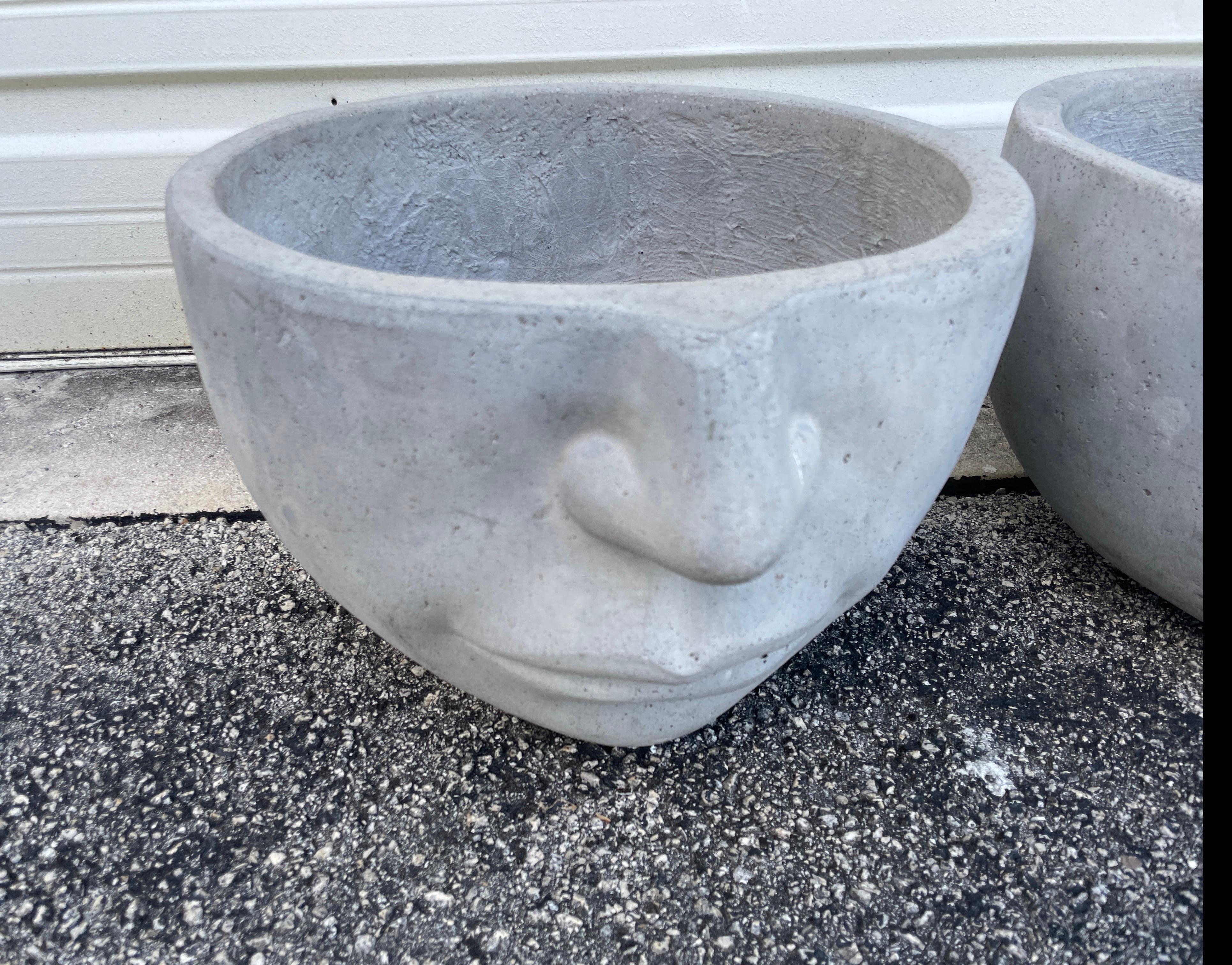 A wonderful pair of modern large face planters. A nose and mouth protrude on one side, 