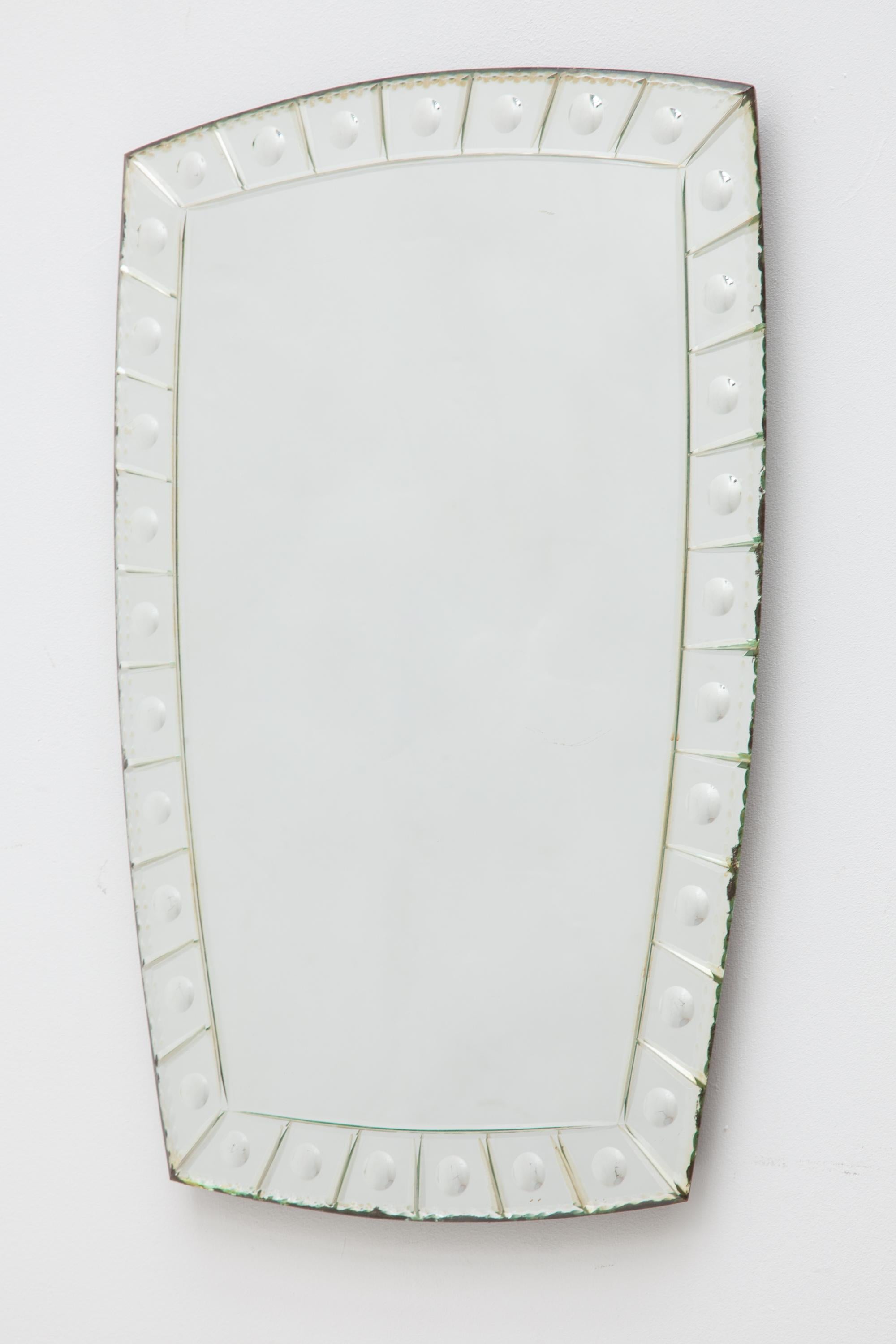 A classic Art Deco mirror with a beveled edge. Horizontal rectangle shape. Backed by a wooden frame.