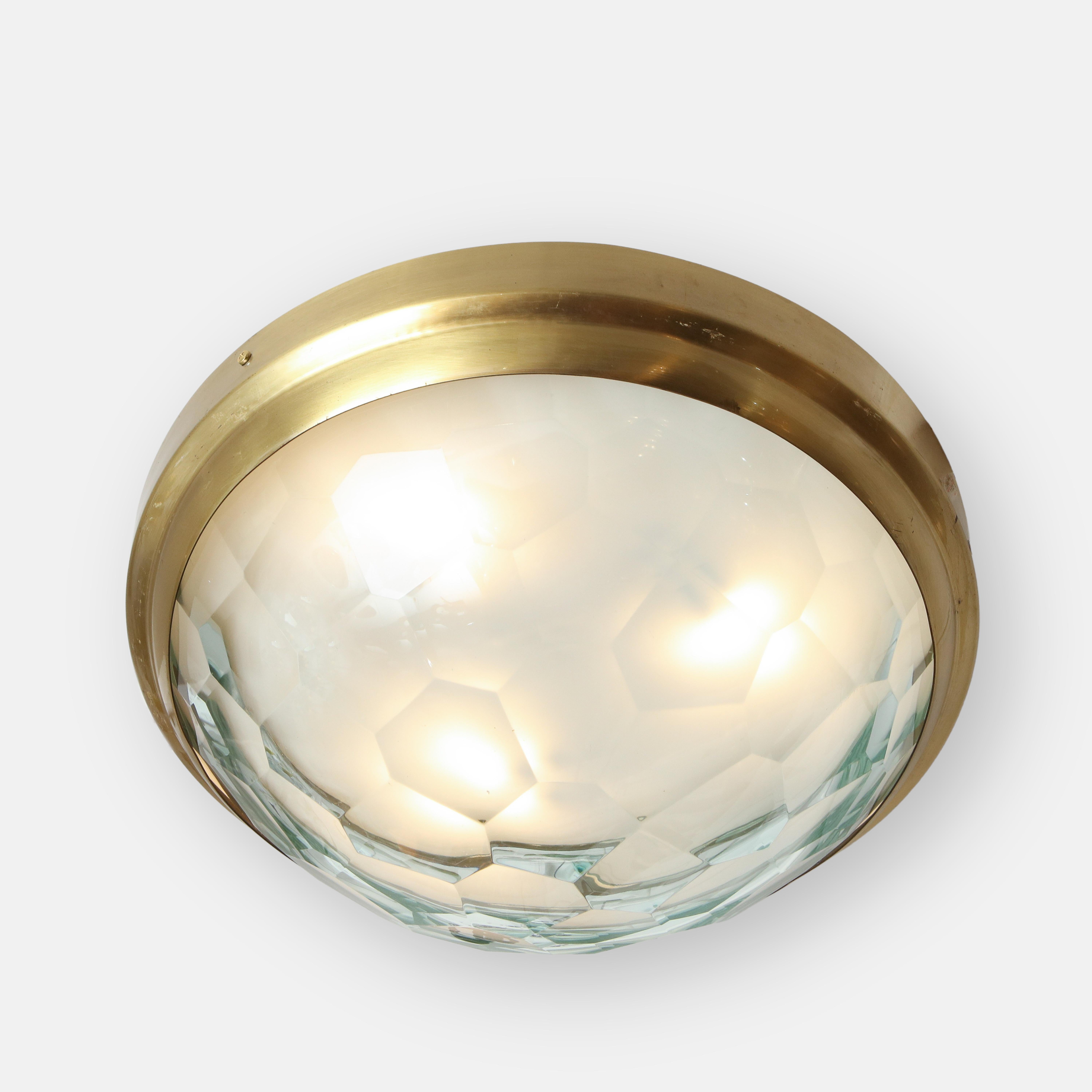 Elegant large flush mount ceiling light in the style of Fontana Arte with faceted glass diffuser on brass mount, Italy, 1960s. This lovely ceiling light reflects the light beautifully as it diffuses it through the faceted glass.