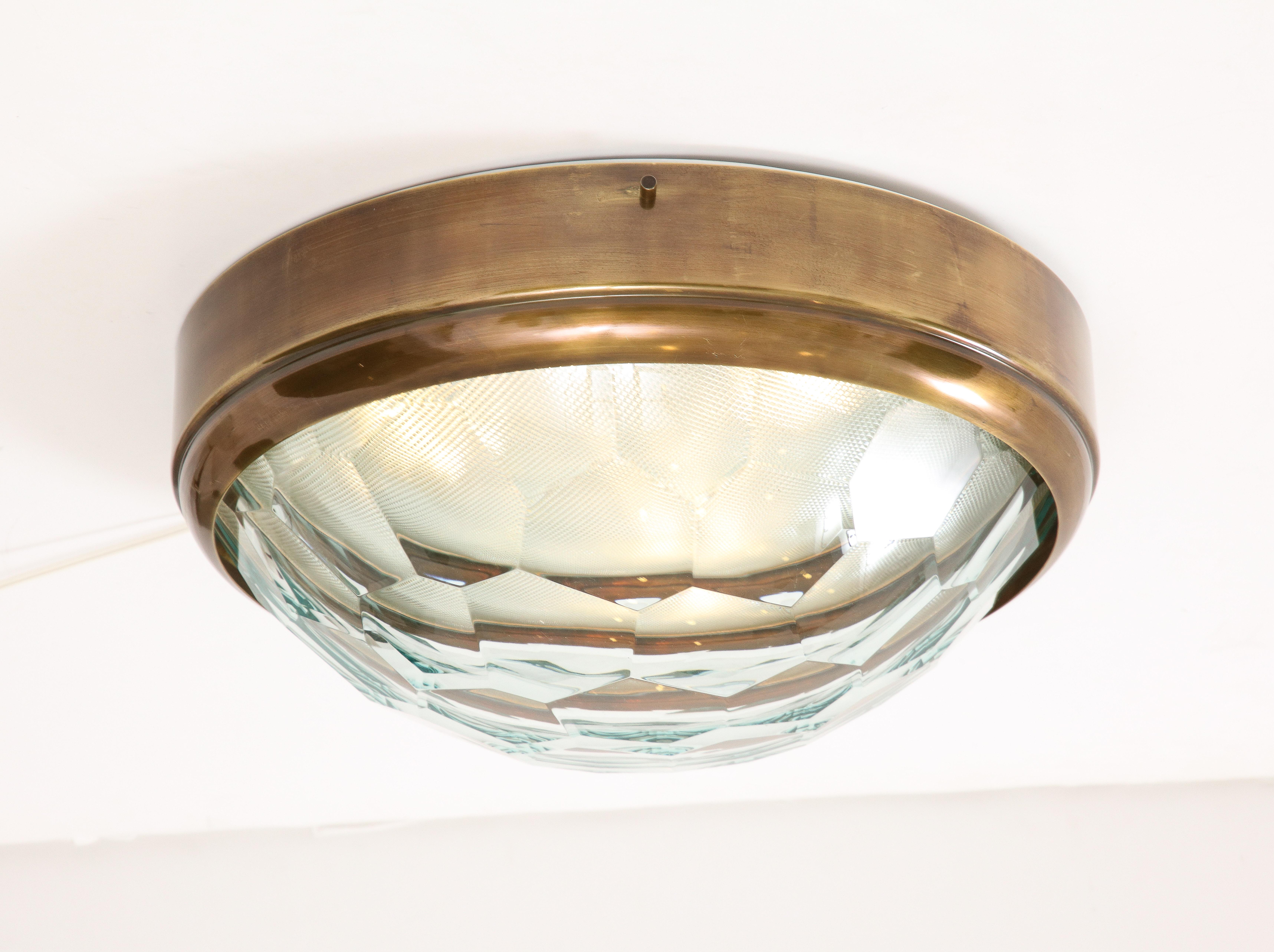 Elegant large flush mount ceiling light in the style of Fontana Arte with faceted glass diffuser on brass mount, Italy, 1960s. This lovely ceiling light reflects the light beautifully as it diffuses it through the faceted glass.
Recently rewired to