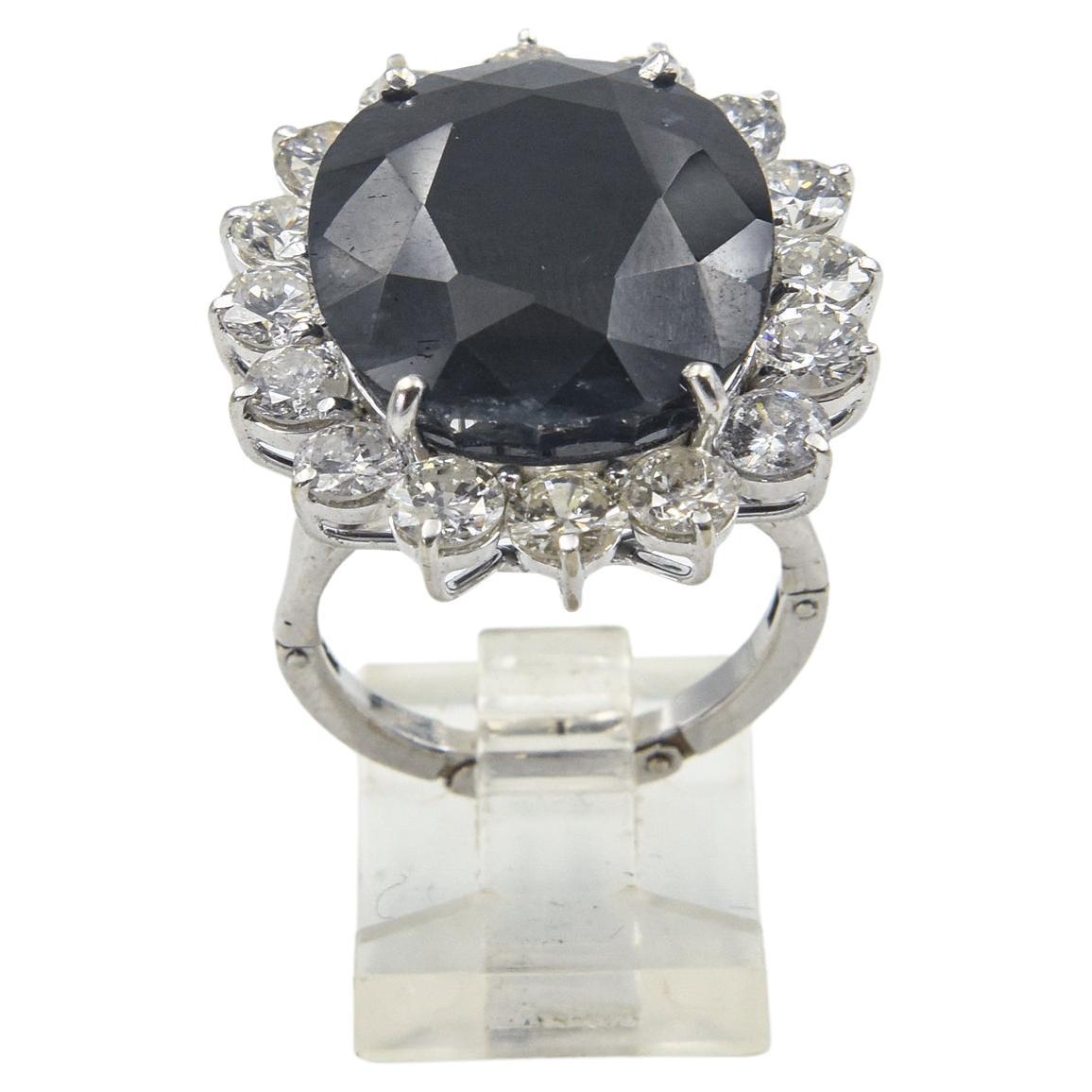 Stunning cocktail ring featuring a dark faceted blue sapphire weighting approximately 30 carats surrounded by 16 diamonds with approximate total weight of 5.60 carats.  The sapphire has been heated which is a normal practice. The mounting is 14k
