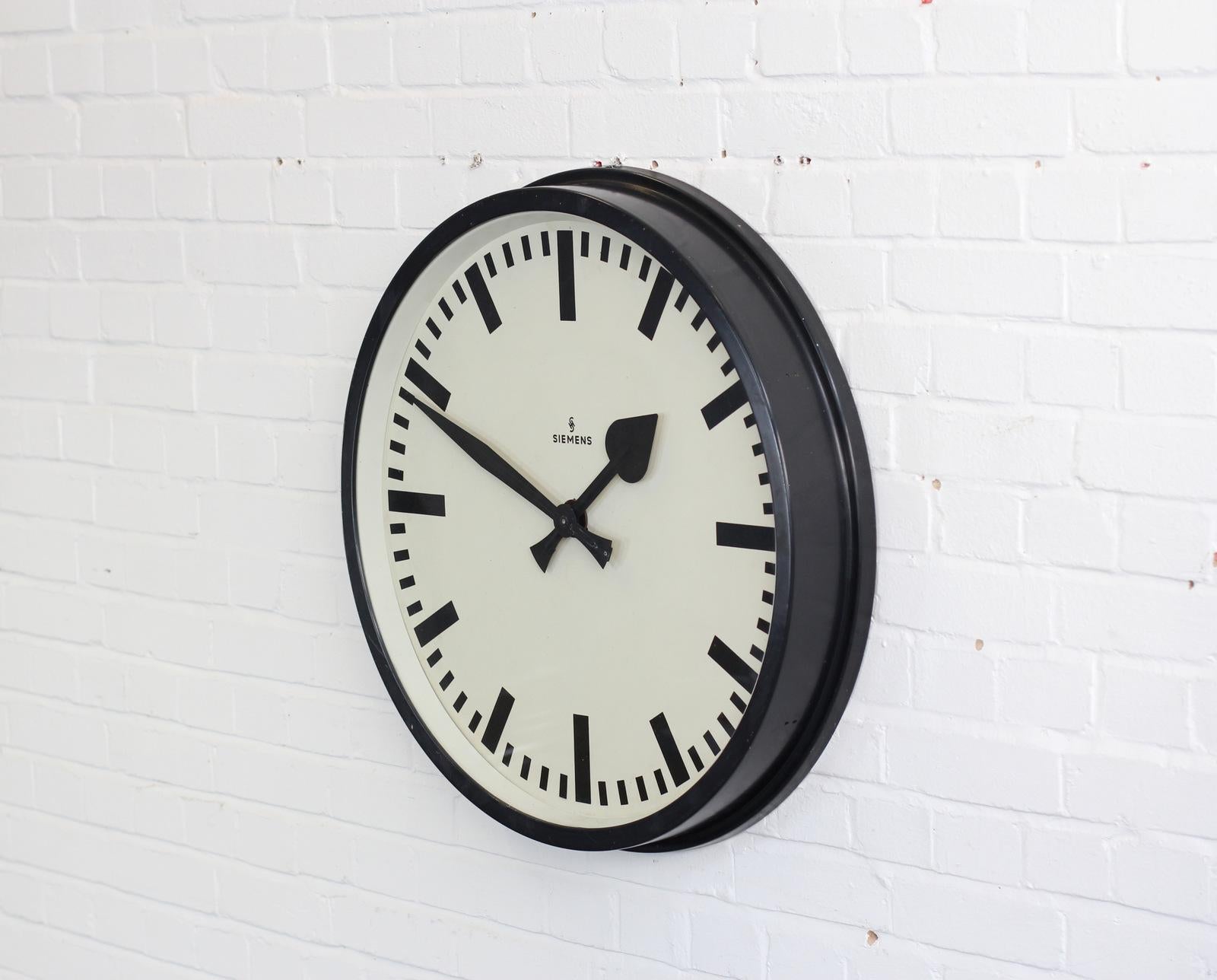 Large factory clock by Siemens, circa 1940s

- Aluminium casing with steel dial
- Glass face
- Original spade hands
- Converted to AA battery powered quartz motor
- German, circa 1940s
- Measures: 72cm wide x 11cm deep

Siemens

Siemens &