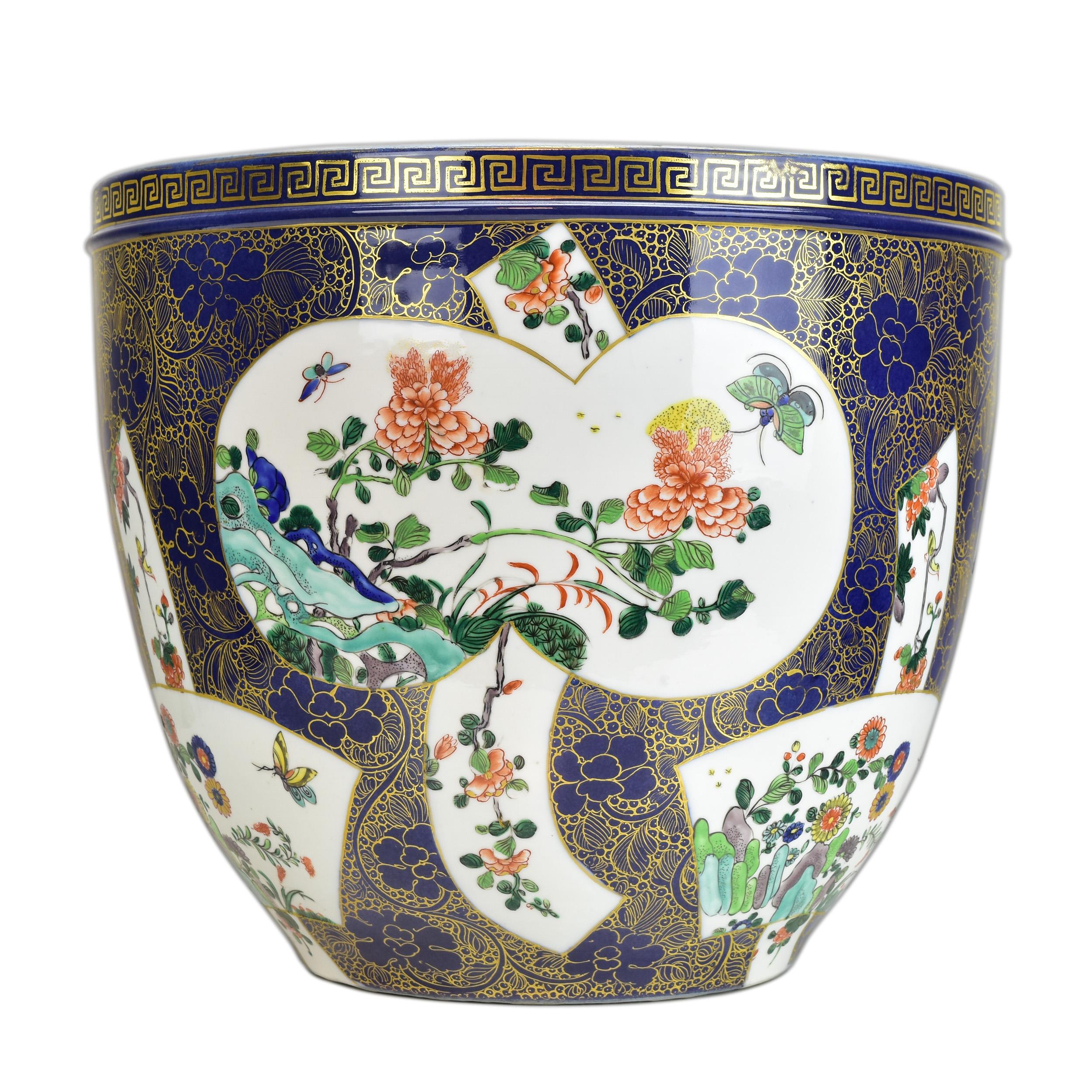 A finely hand-painted large famille rose porcelain planter from the mid-20th century. The planter features intricate hand-painted designs in vibrant colors, typical of the famille rose style. Its sizable dimensions make it a striking decorative