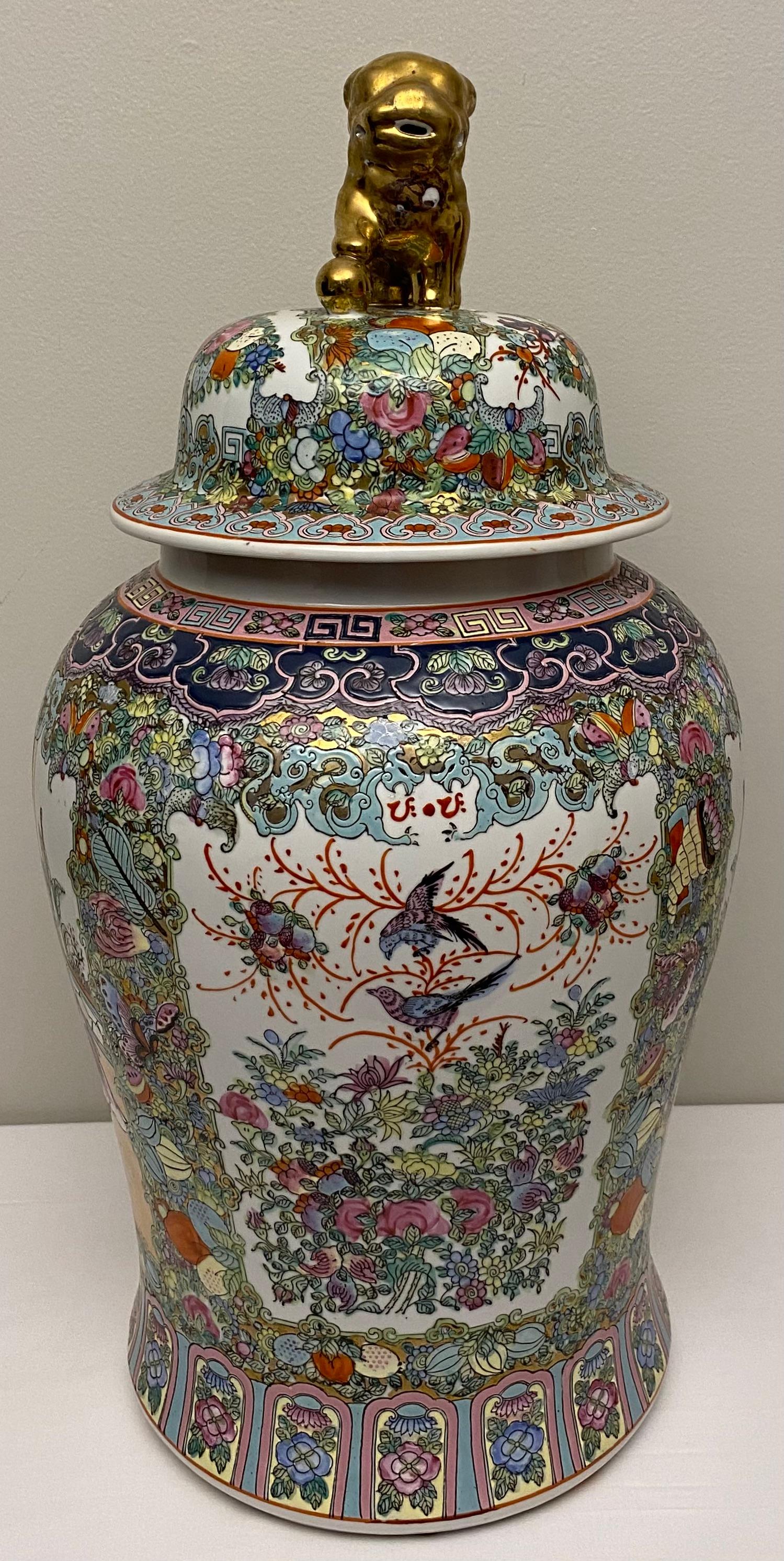 A beautiful, hand-painted Chinese famille rose temple jar decorated with foliage design and floral panels, gold lion dog form the knop of the lid. 

Similar to many fine porcelain temple jars that were manufactured by Samson and Company who were