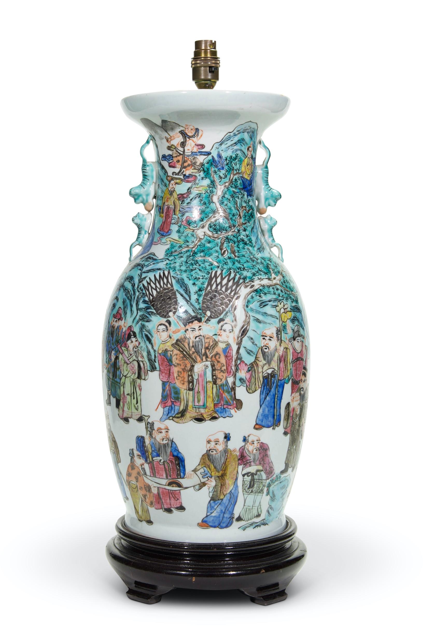 A fine large Chinese famille verte vase of baluster form, beautifully decorated with a procession of Chinese figures wearing traditional clothing within hilly landscape scenery, on a white background, with stylized dragon handles to the neck, now