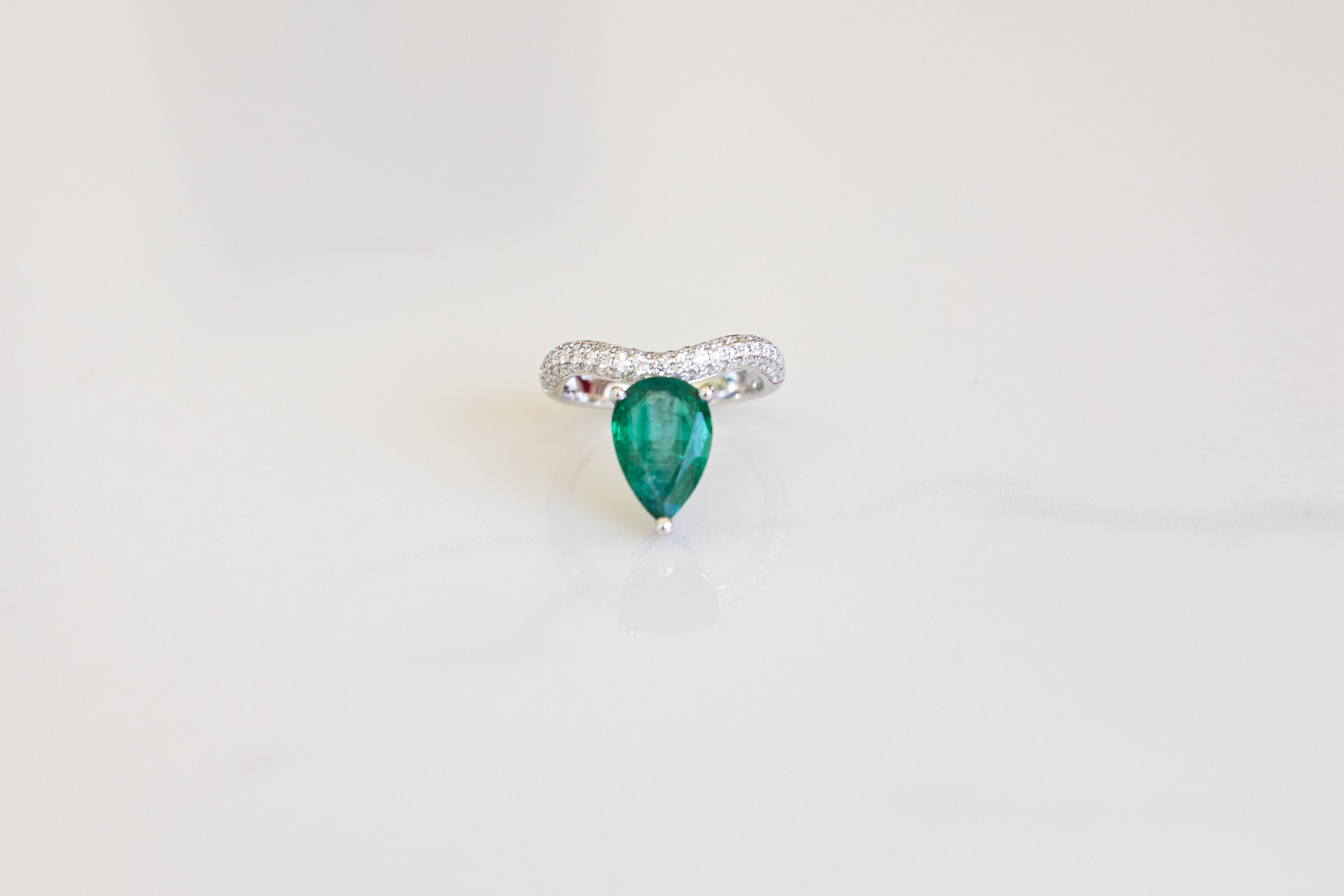 Make a statement with this significant 2.58 ct Pear shaped emerald solitaire and brilliant cut diamonds wave ring (ONE OF A KIND). Great for a stand out engagement ring or a statement any finger ring!