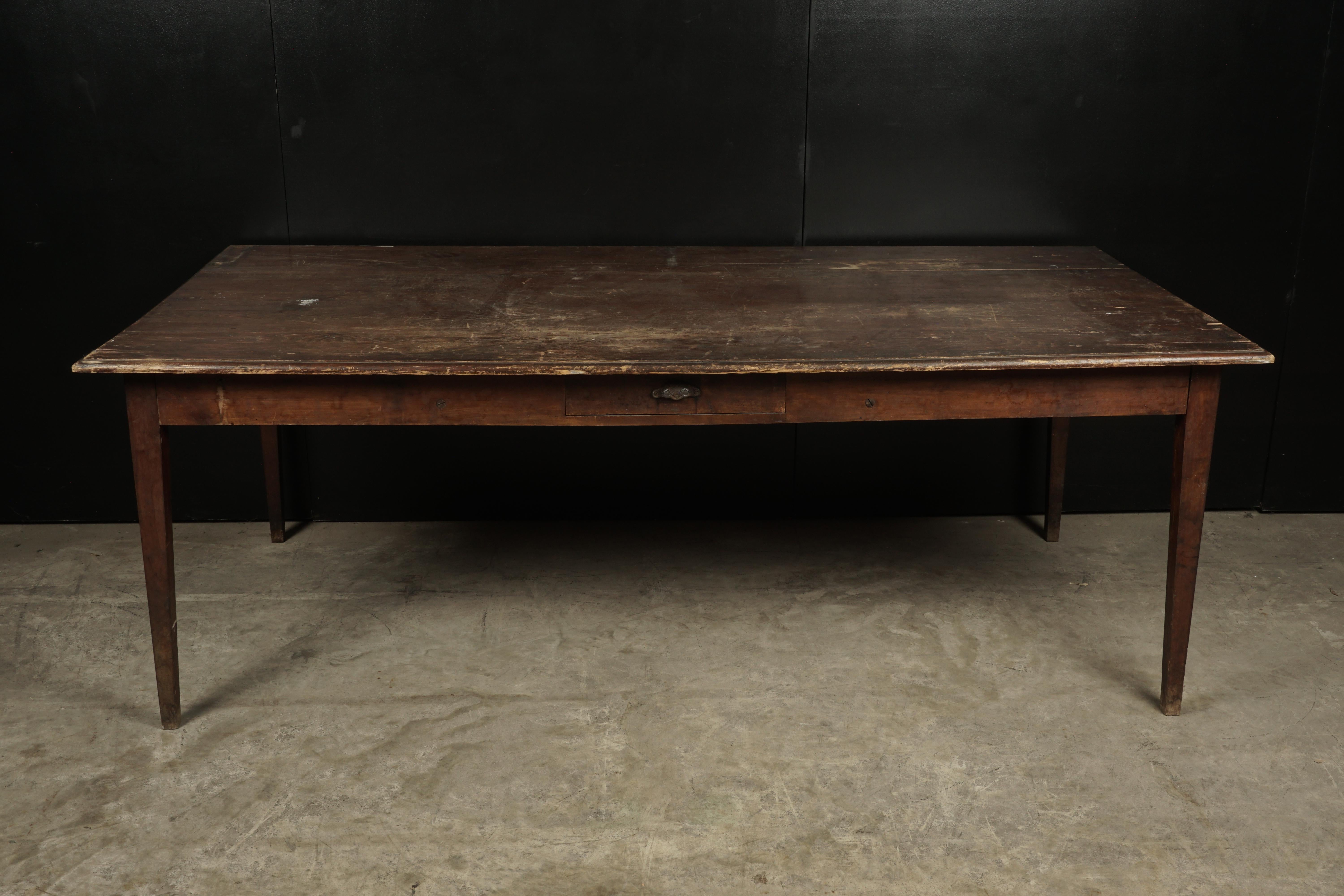 Large farm table from France, circa 1920. Solid pine construction with two drawers. Top with nice patina.