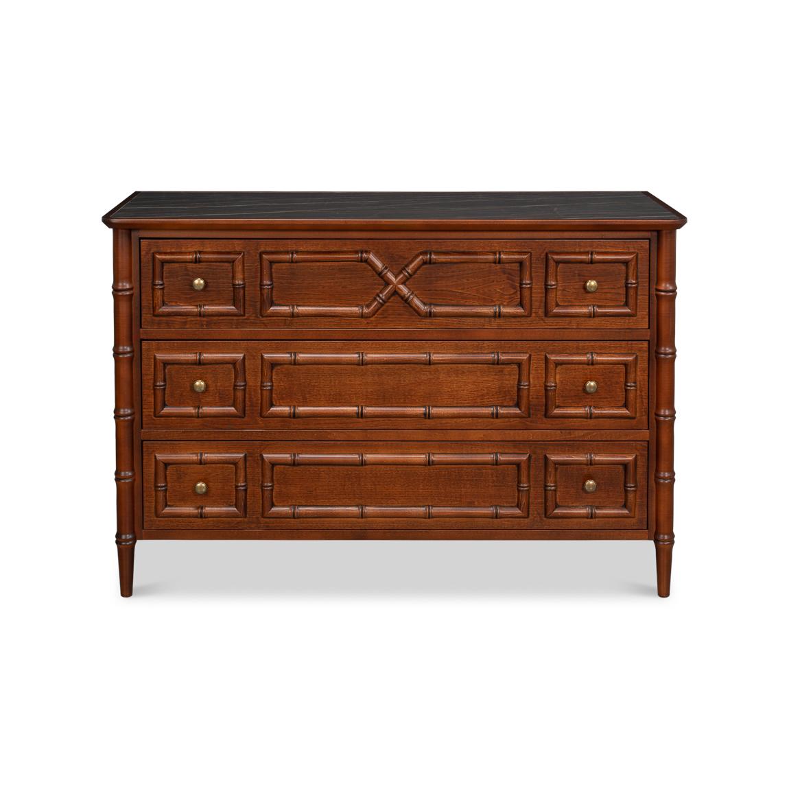 Inspired by British Colonial influences, it features refined faux bamboo moldings along the drawers and corners, adding a sense of texture and craftsmanship.

Finished in a warm tone, the wood’s rich character is beautifully complemented by a dark