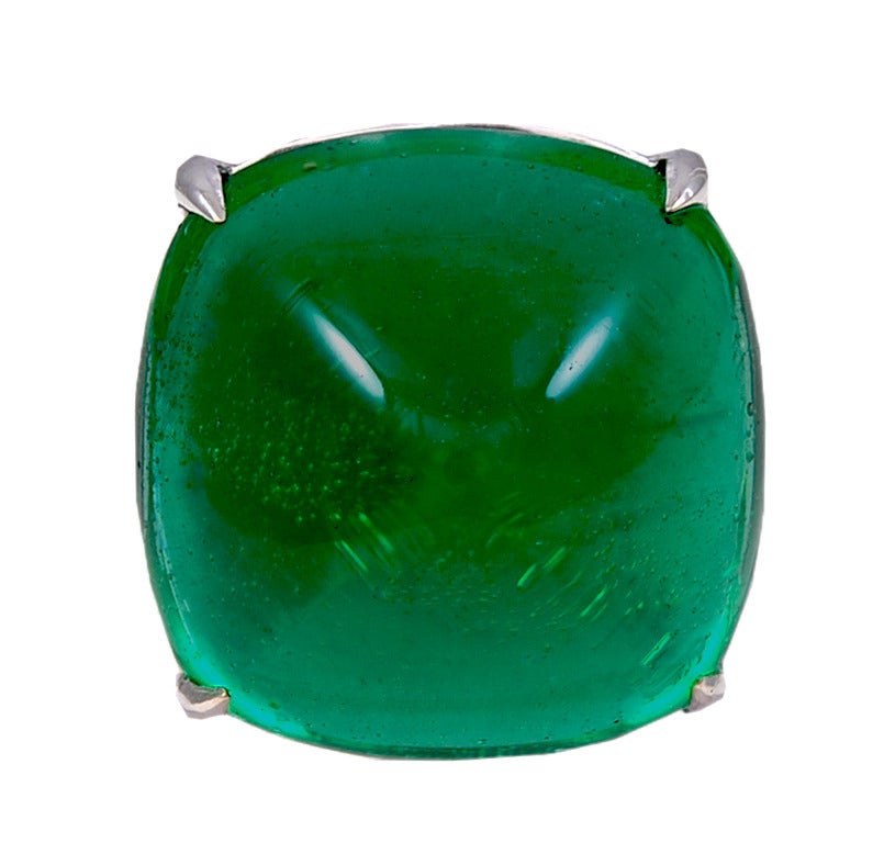 A unique man-made large French cut pyramid Colombian colour emerald  half-moon Cubic Zircon set white gold ring. Approximate similar weight, if real would be around 35 carats.

This ring is so amazingly real looking we suggest the buyer takes care